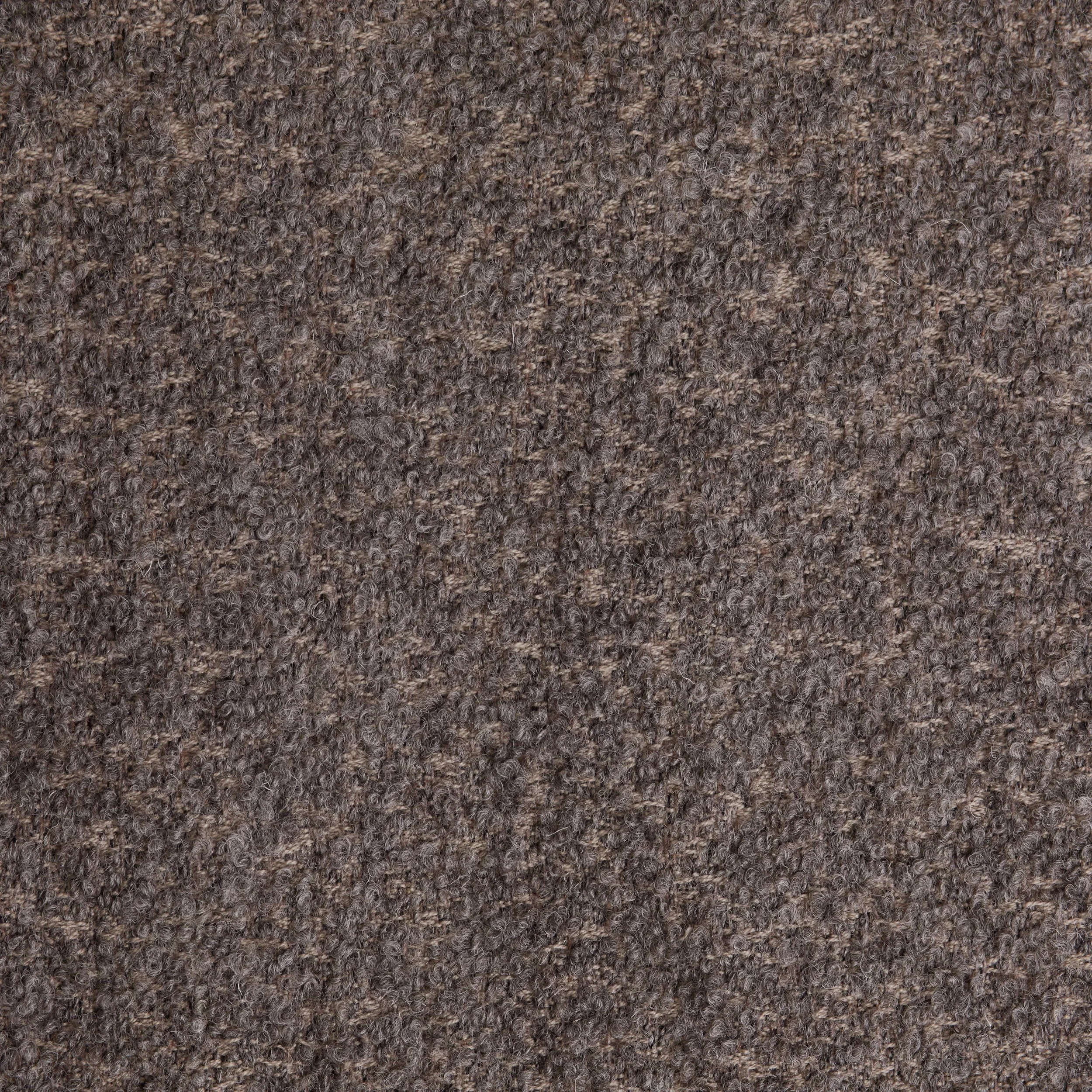 Close-up of a textured brown carpet.