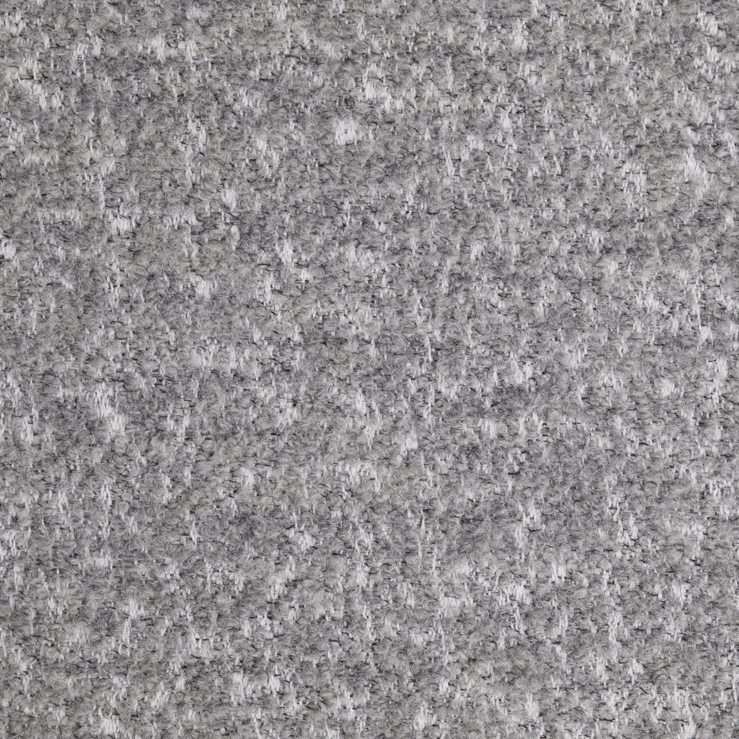 Close-up of a light gray, textured carpeted floor.