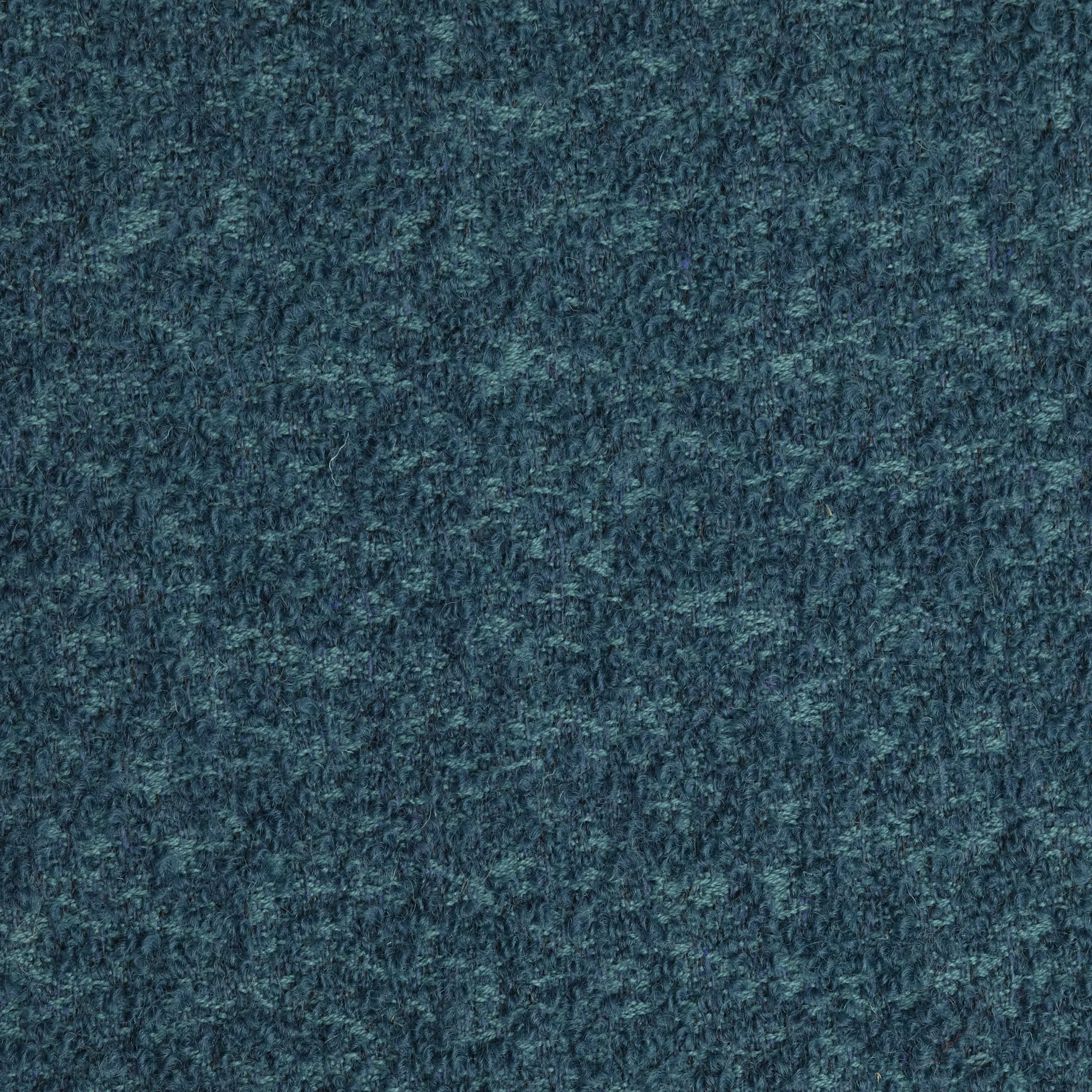 Close-up of a textured blue fabric surface.
