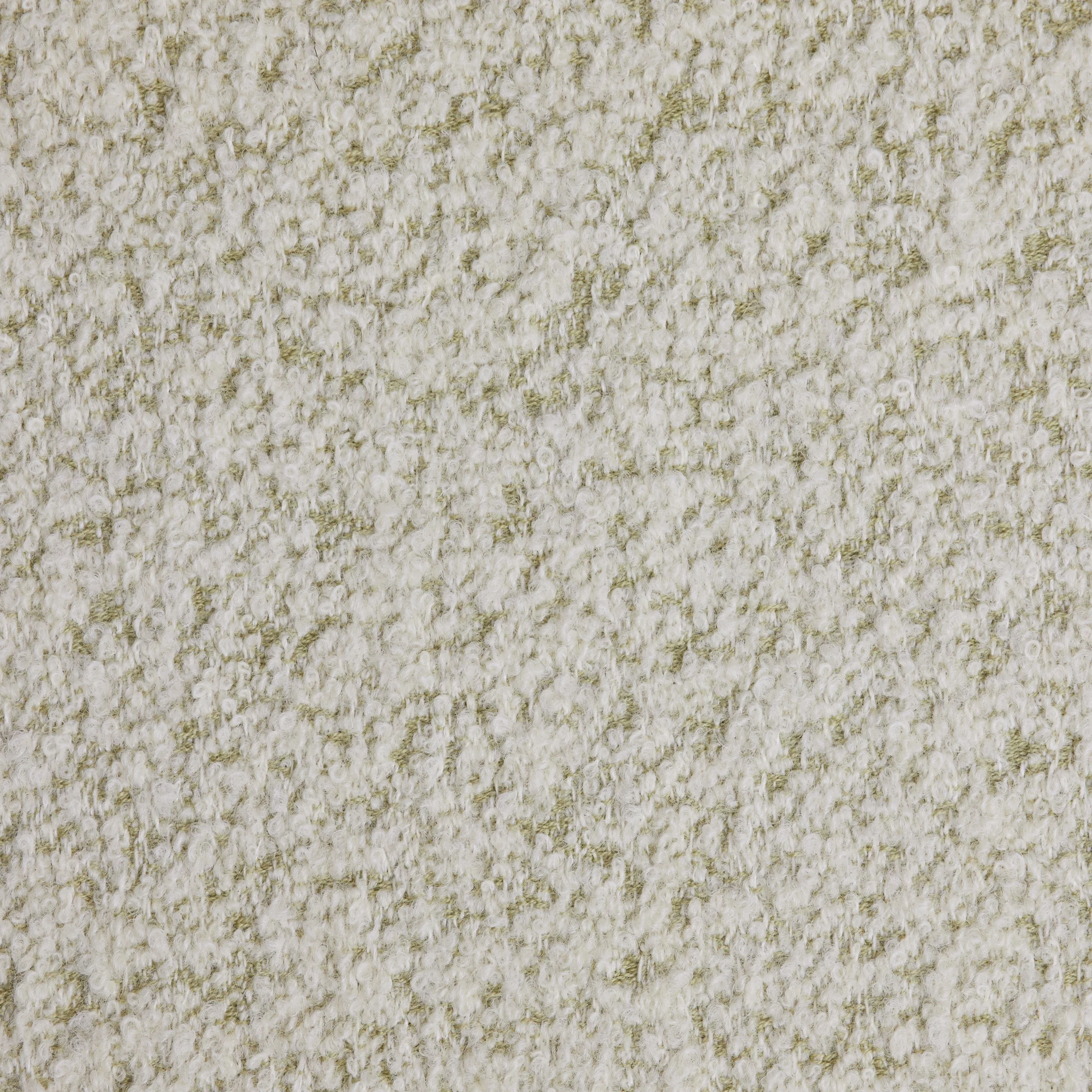 Close-up of a textured cream-colored carpet.