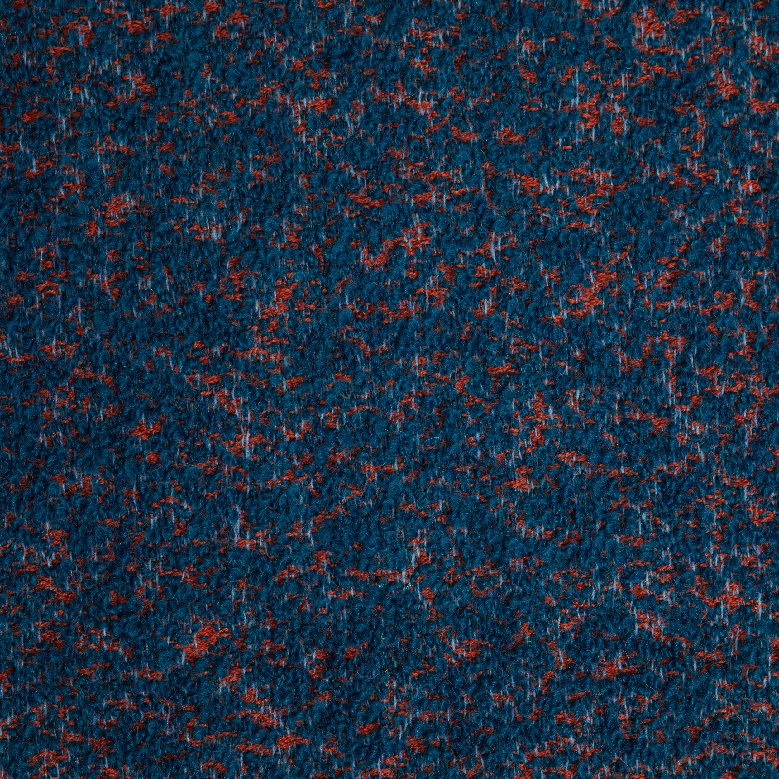 Close-up of textured blue and red patterned carpet.