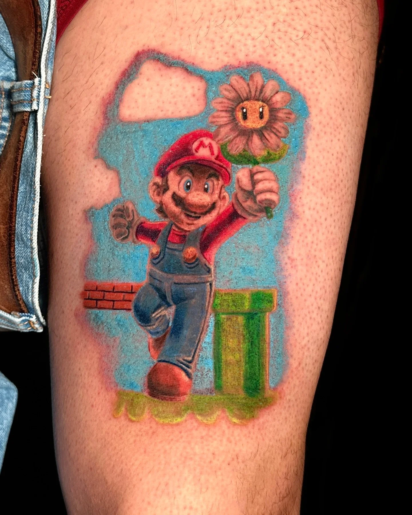 It&rsquo;s-a me, tattoo time! Taking it back with this Super Mario banger. For the gamers, dreamers, and nostalgia seekers. Custom piece that represents his mom (a daisy) and Mario (his dad). 

Done at @aztekink 

#supermario #supermariotattoo #tinle