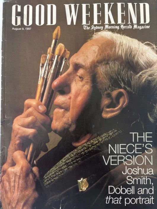 Front cover of Good Weekend Magazine. It's a colour head and shoulder image of an old man, holding up a bunch of paint brushes close to his face. On his chest is a war medal. Text: The Nieces Version; Joshua Smith, Dobell and that portrait.