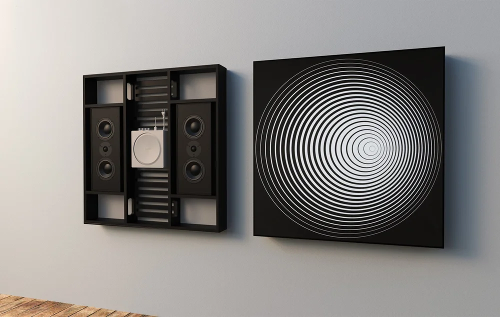 Leon Ente SoundTile wall-mounted speaker beside circular artwork