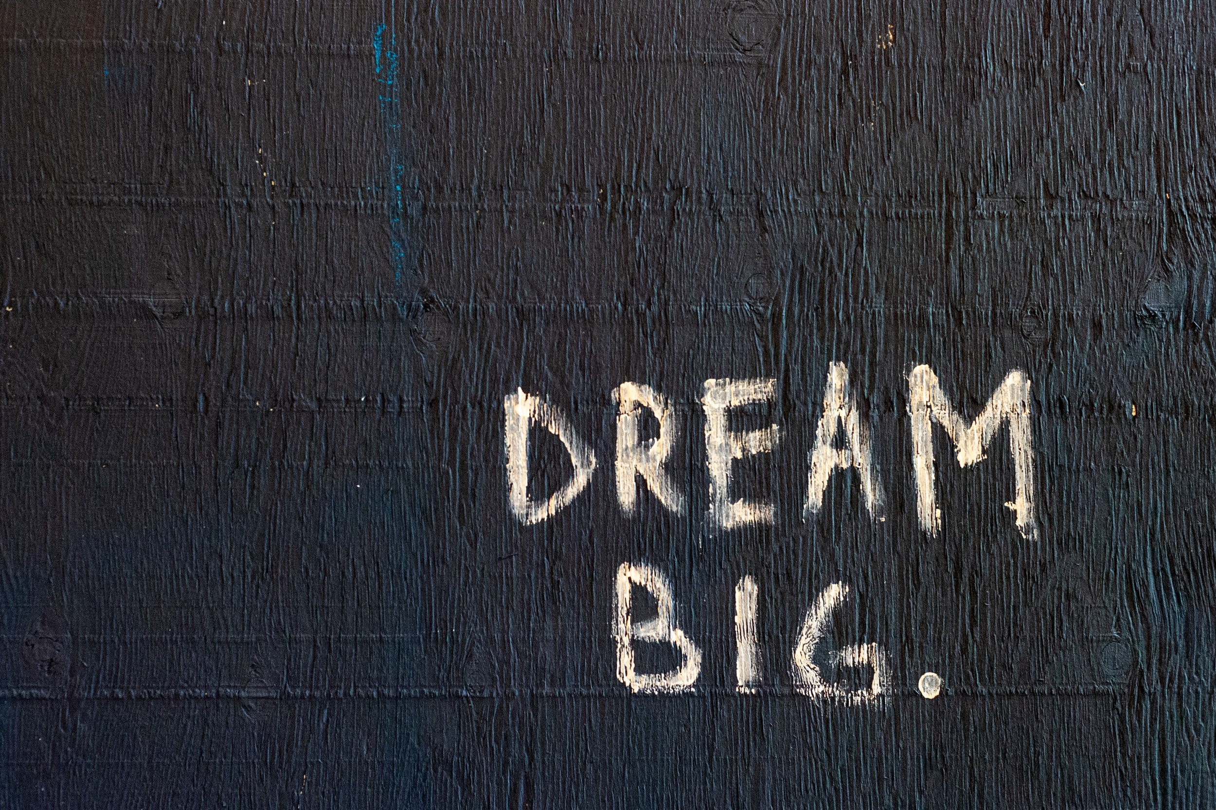 Wall with graffiti text 'Dream Big.'