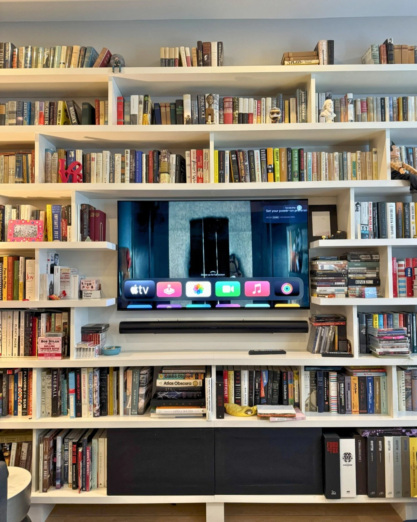 Sometimes the smartest technology is the one you don&rsquo;t notice&mdash;until you use it.

This custom media wall blends seamlessly into the home&rsquo;s library aesthetic, hiding high-performance audio and video technology in plain sight. Whether 