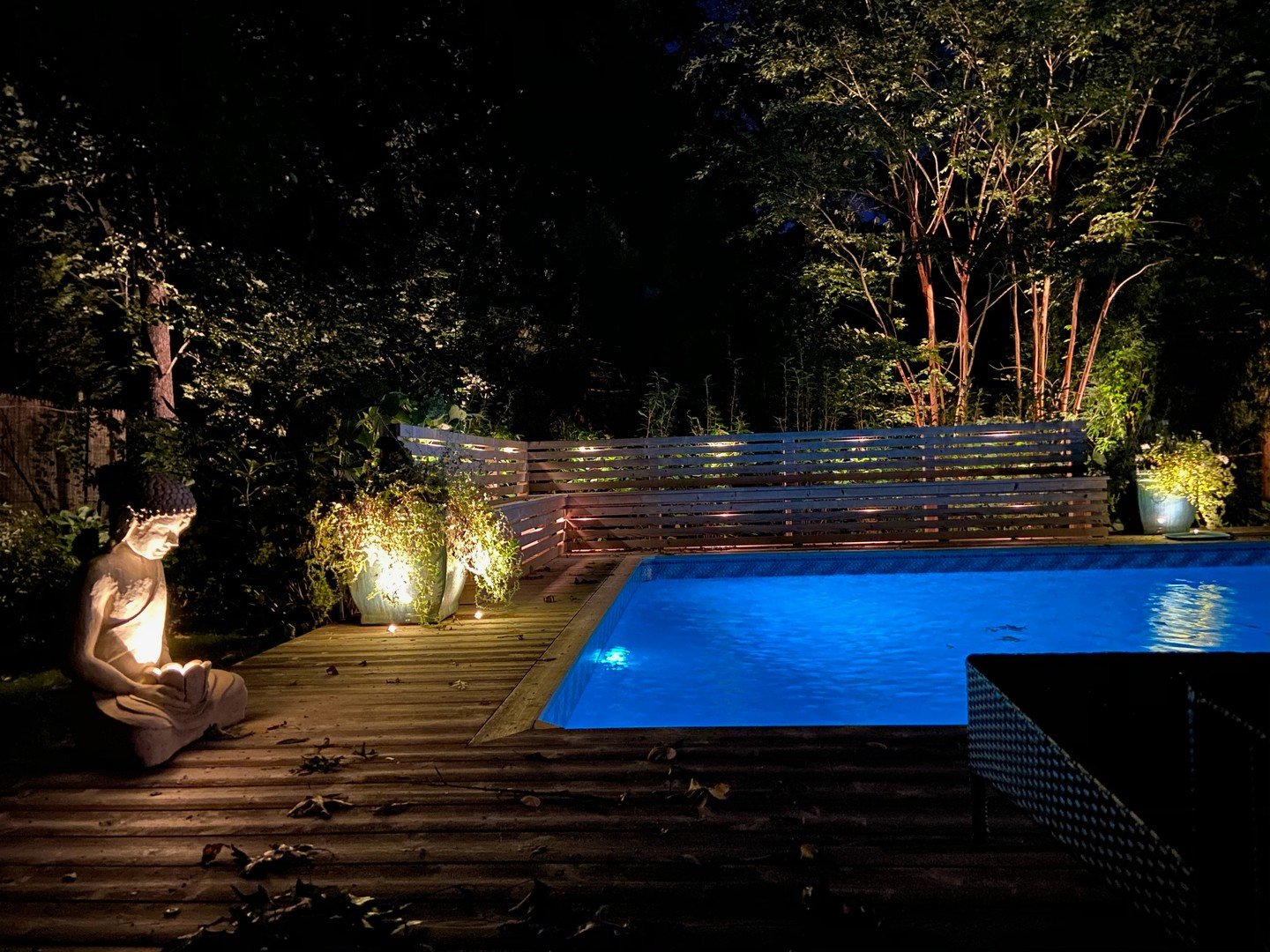 The trick to a backyard that feels like somewhere you'd book a room is not more light. It's better light.

Layered uplighting on the architecture, soft accent washes through the planting beds, a discreet glow at the water's edge &mdash; each one doin