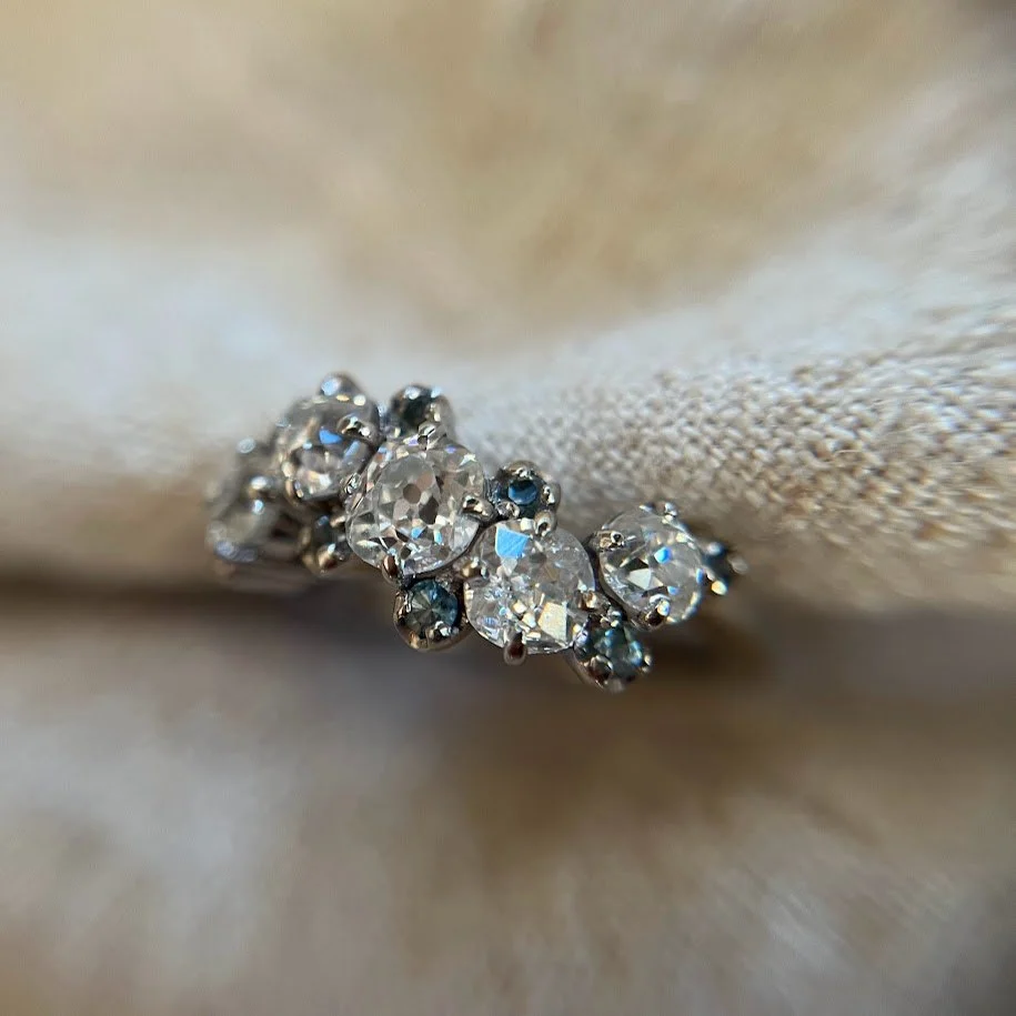 Stunning old cut diamonds and teal sapphires set in platinum.