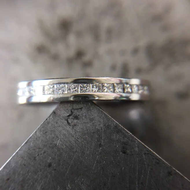 Princess cut diamond and platinum wedding band