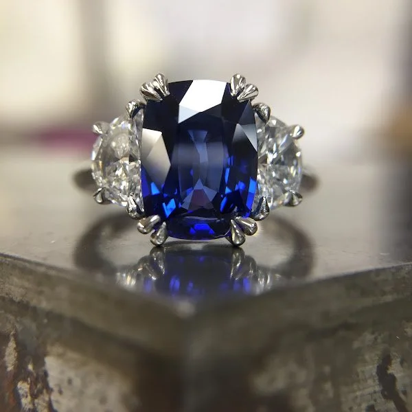 Blue sapphire and half moon diamonds in platinum