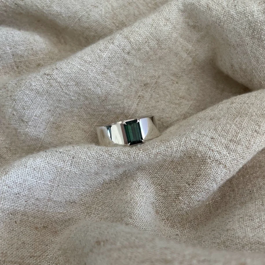 Sterling silver wide band set with a teal tourmaline.