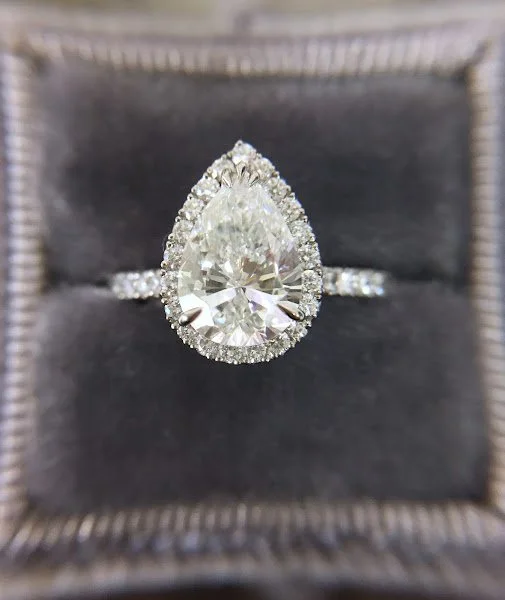 Pear shape diamond with a halo set in platimum