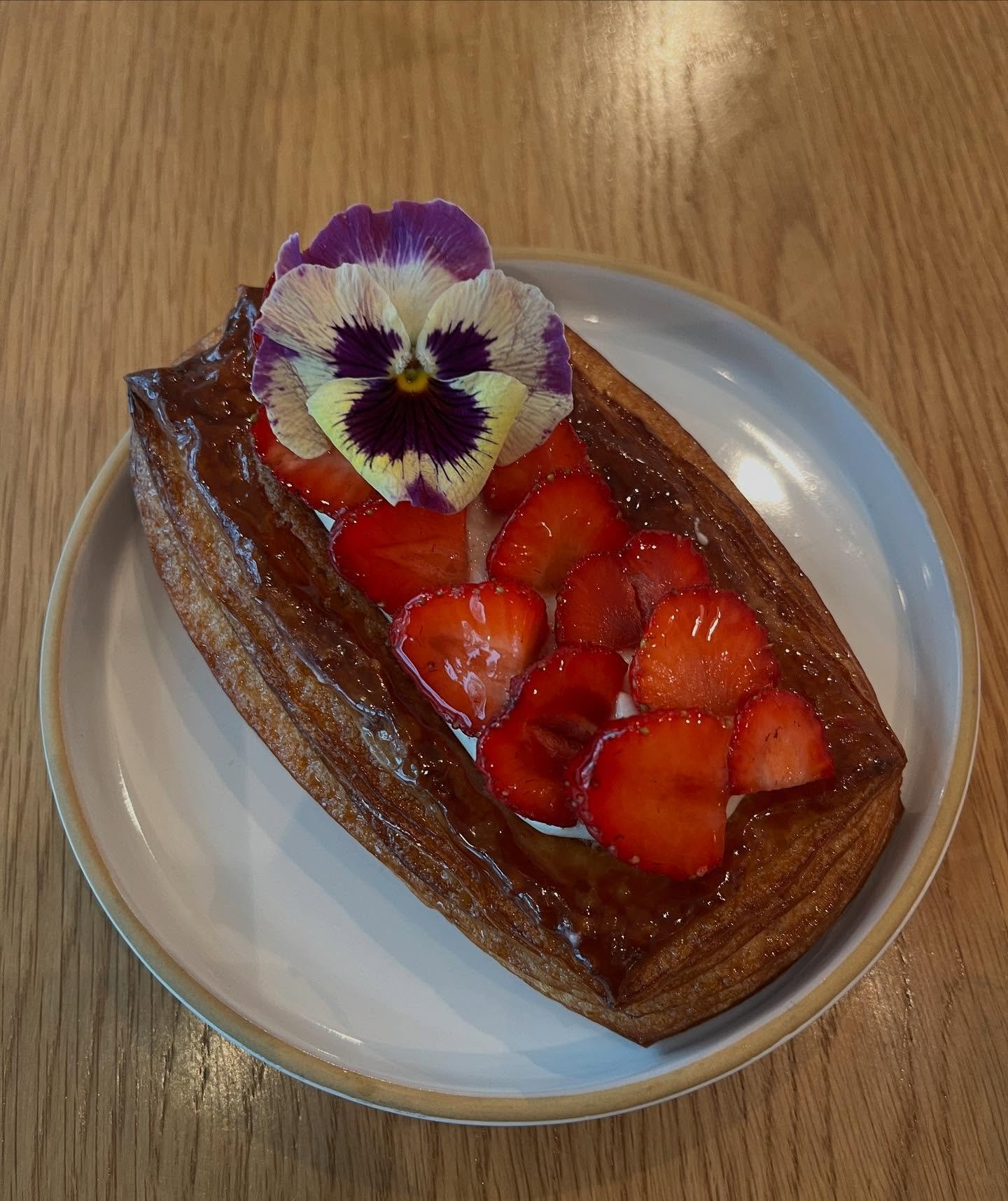 Strawberry shortcake!  We are bringing this back from last year with a bit of a revamp!  Each tiny local strawberry from @fieldandlarder is sliced in half and meticulously placed on top of our vanilla cream cheese filling and almond frangipane.  The 