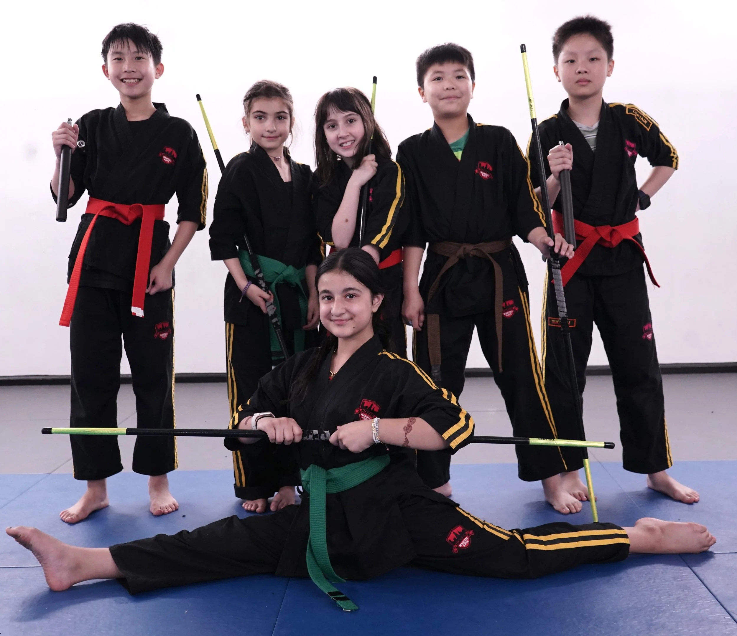 Youth martial arts students practicing escrima stick training at Modern Martial Arts NYC dojo