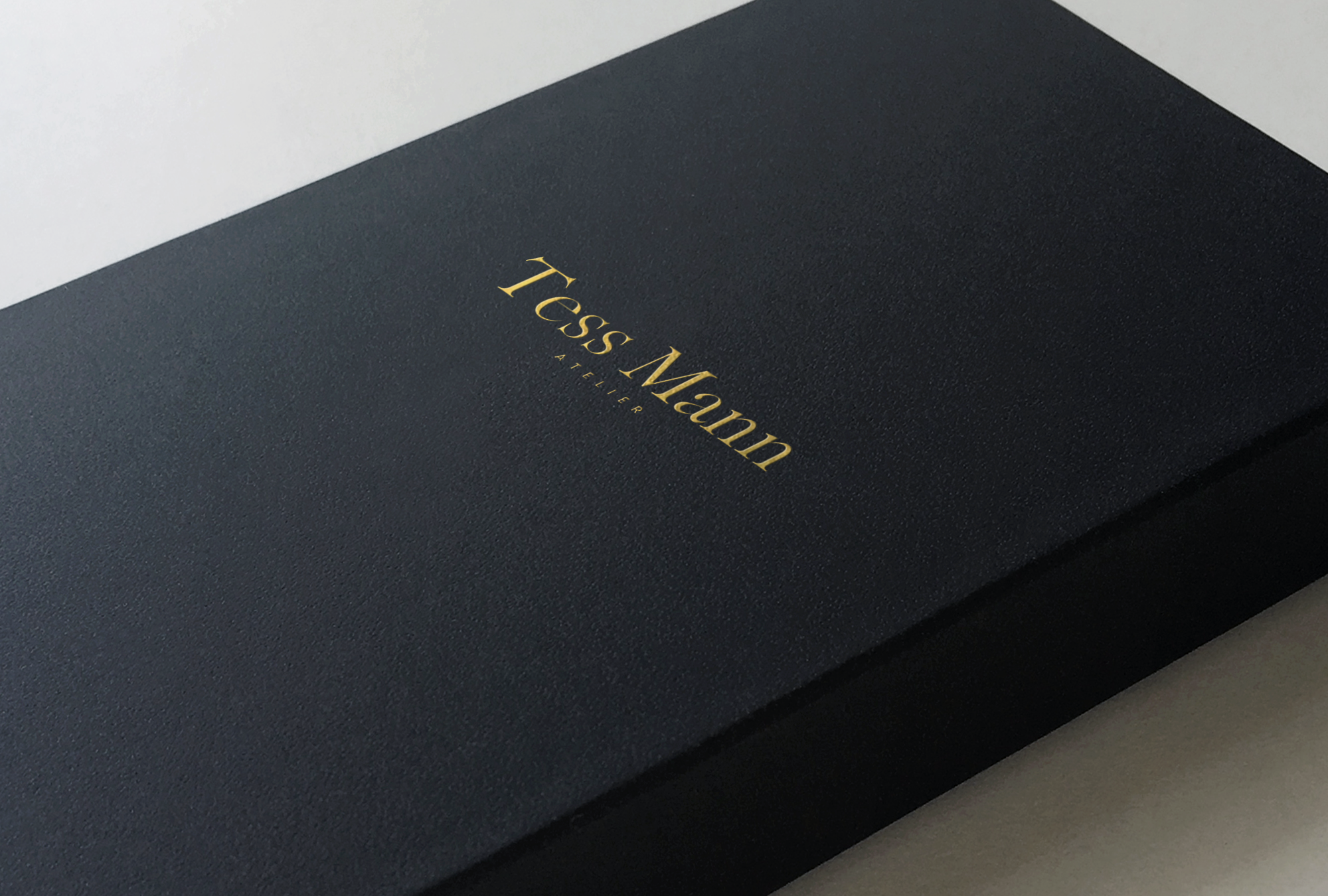 Close-up of a black textured envelope or package with gold embossed text that reads 'TCLASS M'.