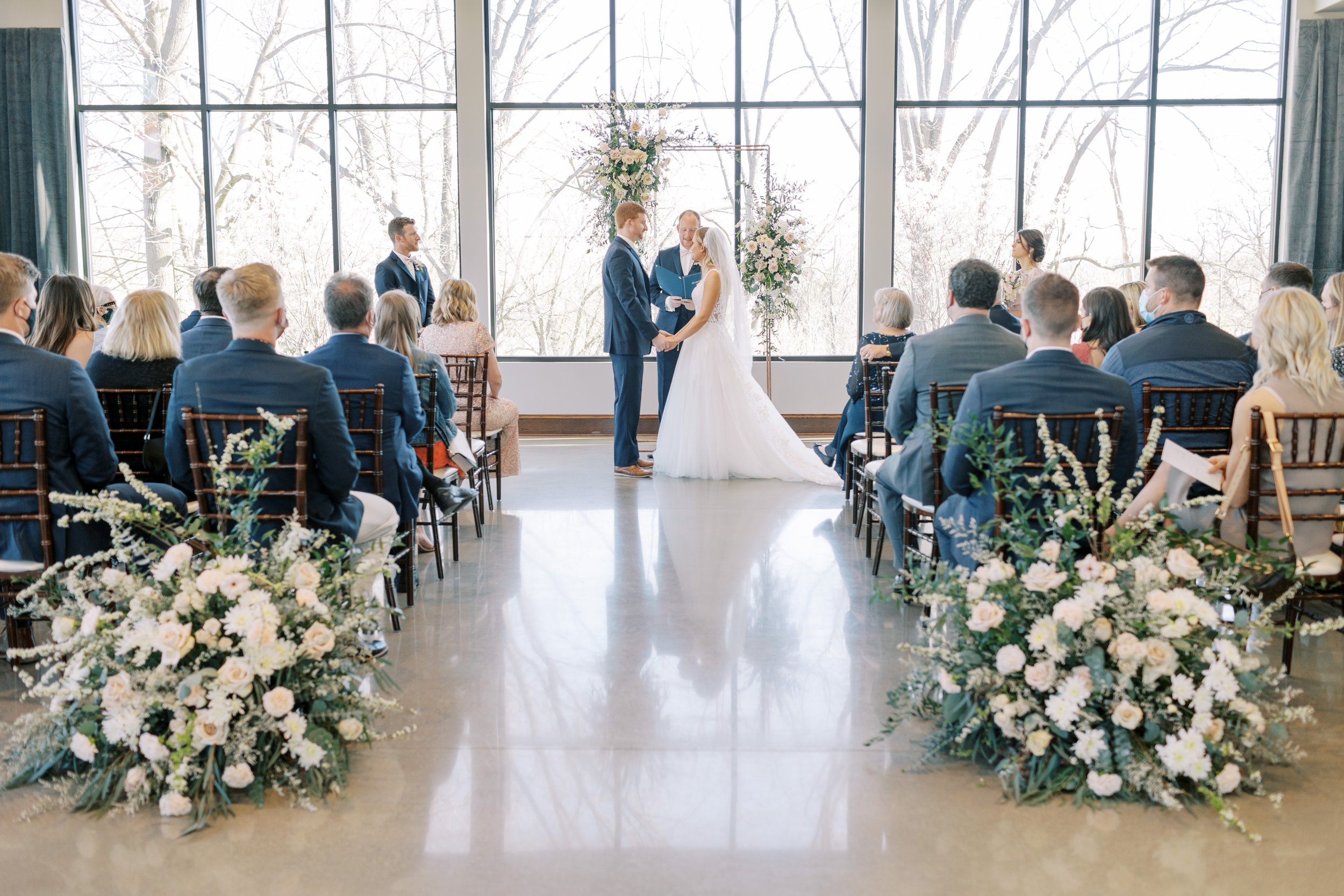 Couple exchange wedding vows in conservatory at Venue3Two