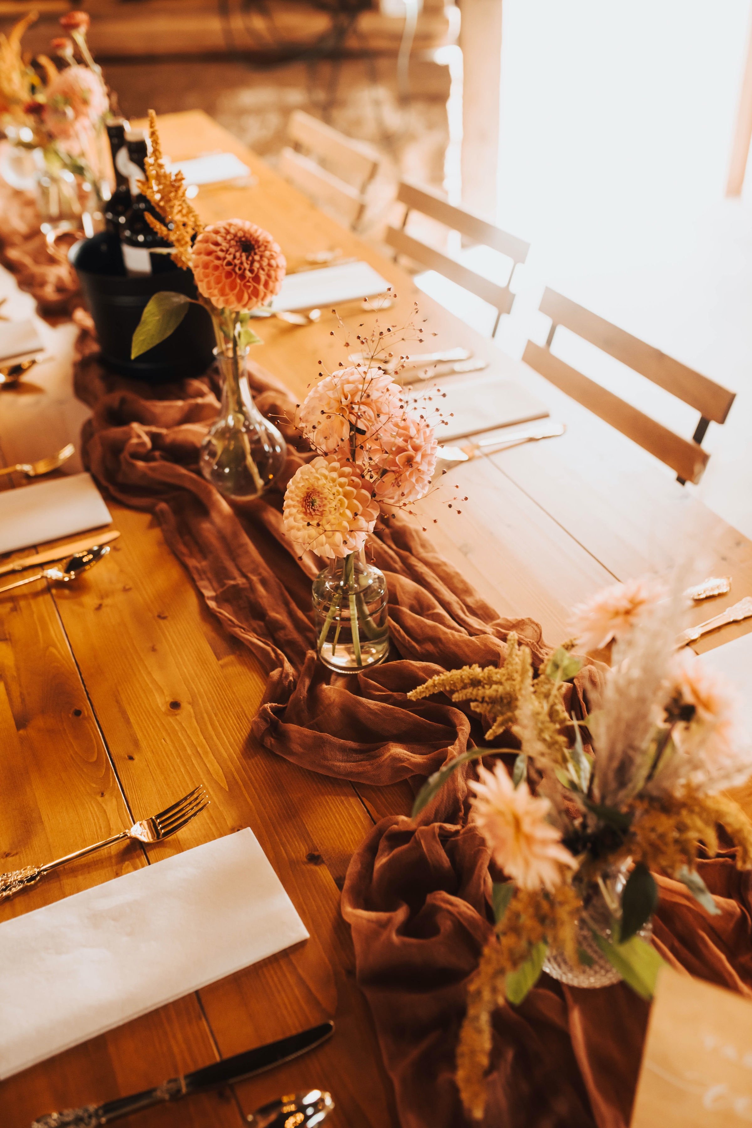 Fall budvases on reception table at boho wedding reception at Bear Creek Farm