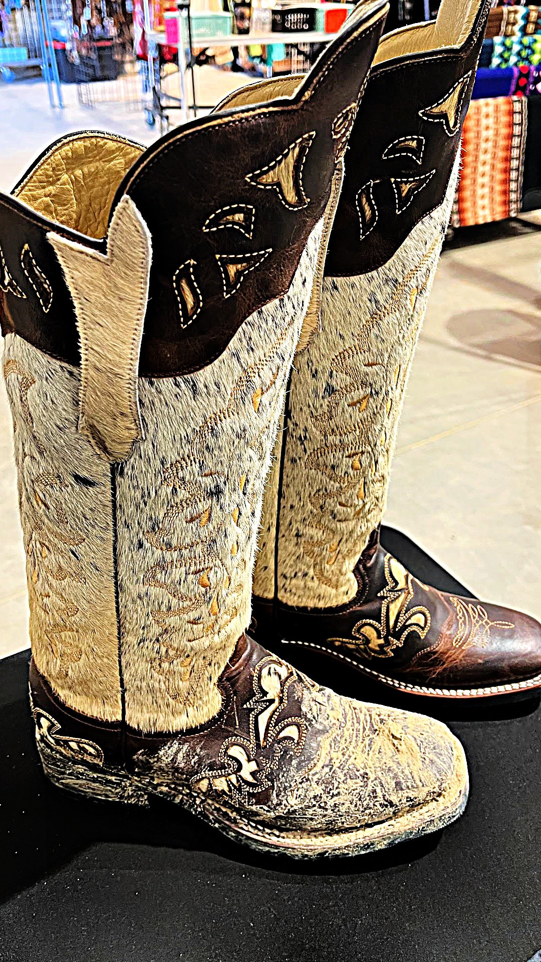 A display pair of Lacy Boots brand boots with one dirty, and one cleaned and conditoined by Healthy Leather.