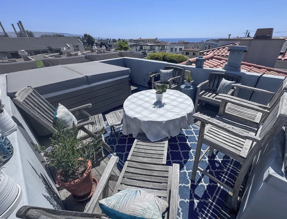 Roof deck with jacuzzi and fire table.