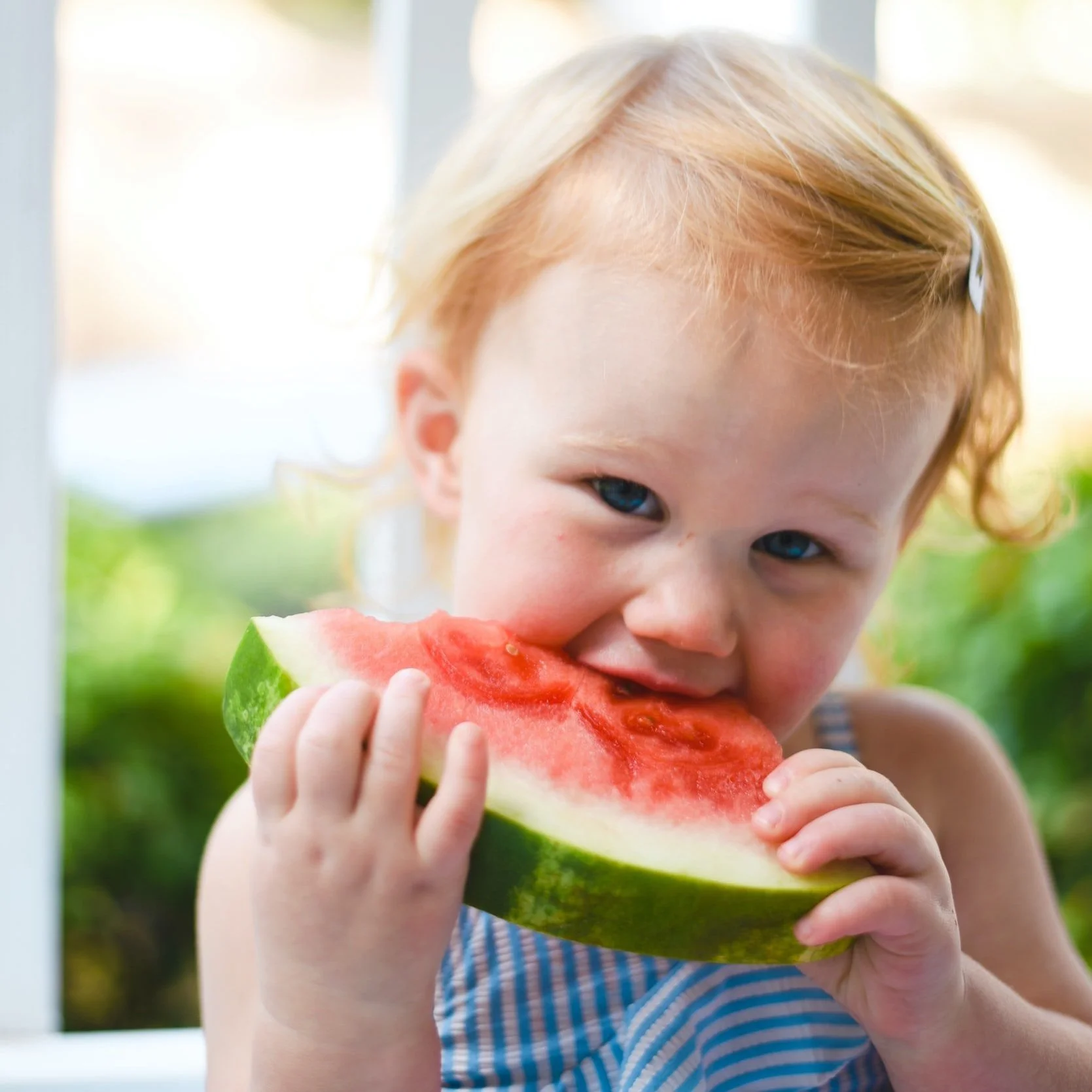 child eating watermelon