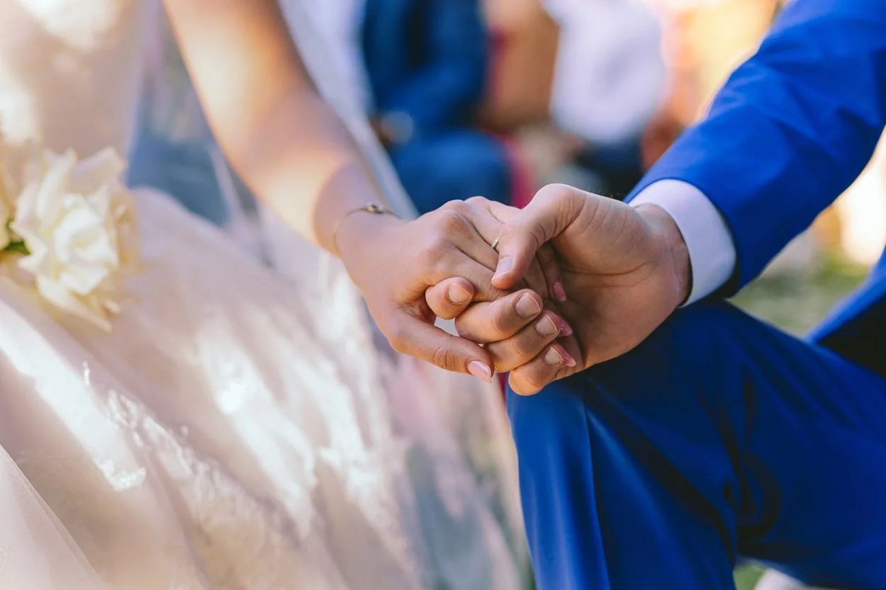 detail of bride and grooms hands
