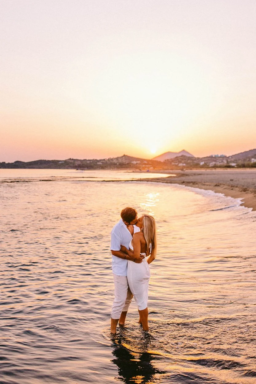 Couple kissing at the beach after sunset