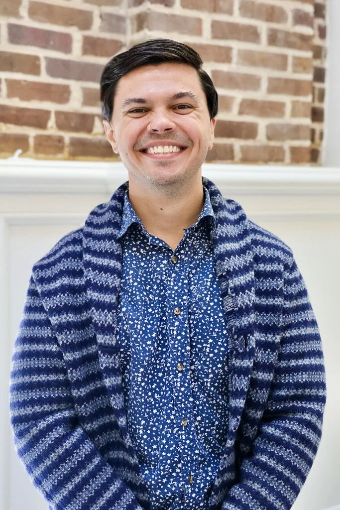 Pictured is Clinical Director and Therapist Steven Gilpin, Wearing a blue flower shirt and a blue and white striped cardigan.
