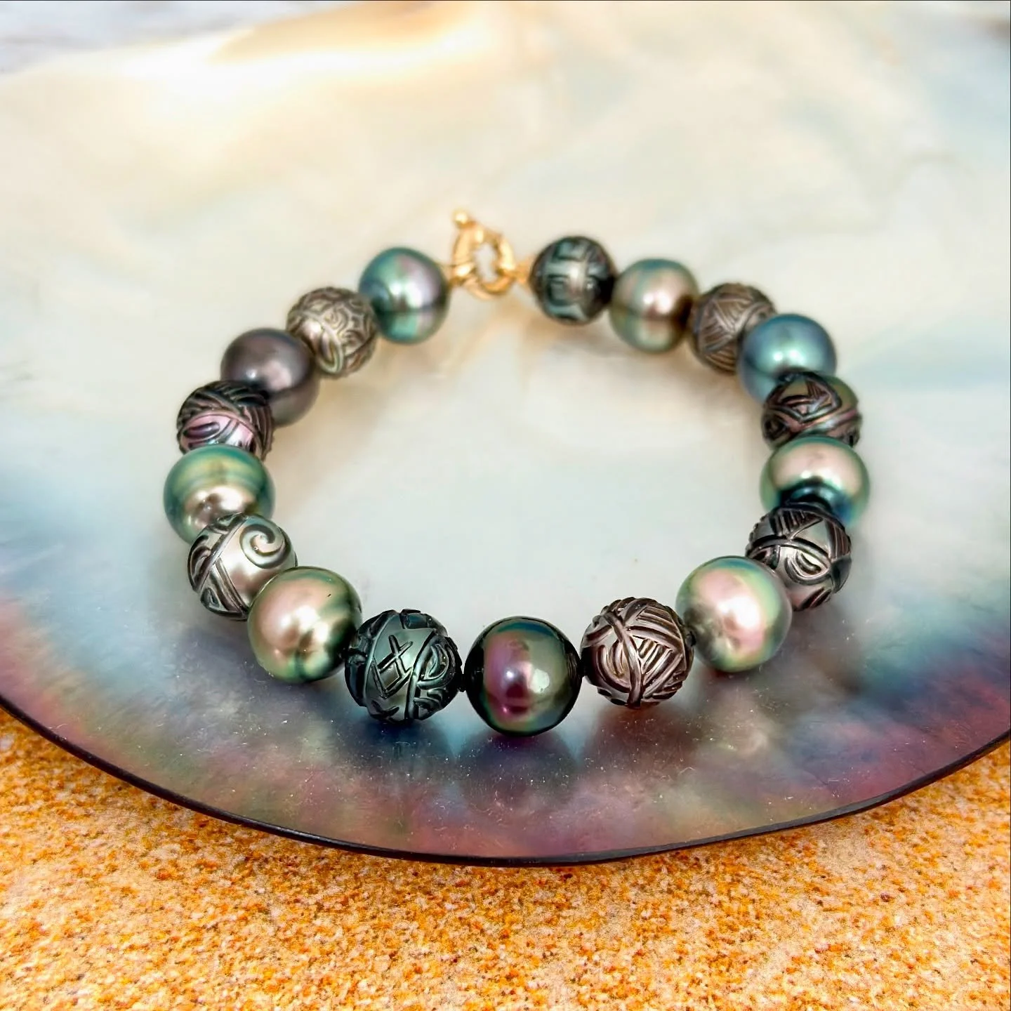 ✨ Carved Beauty, Island Soul ✨
This stunning Tahitian pearl bracelet features intricately hand-carved Polynesian designs and a rainbow of natural multicolor pearls &mdash; each one a work of art from the lagoons of Tahiti. 🌊🌺

Every pearl tells a s