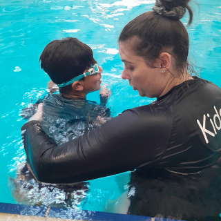 kids plus therapist providing hydro therapy at kids plus swimming pool