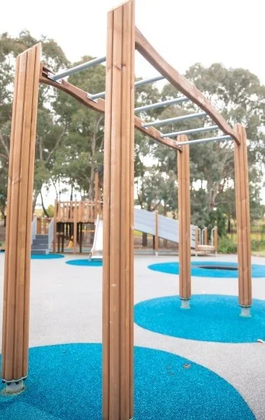 wooden monkey bars in the centre of a playground