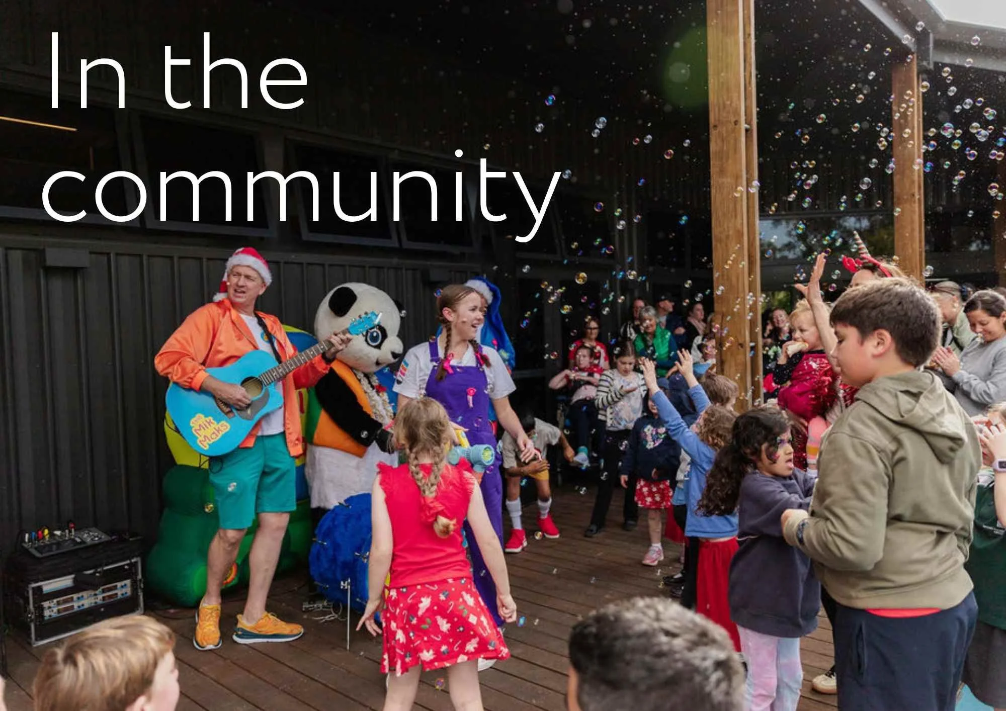 image of the mik maks performing at a party with lots of children, some are blowing bubbles