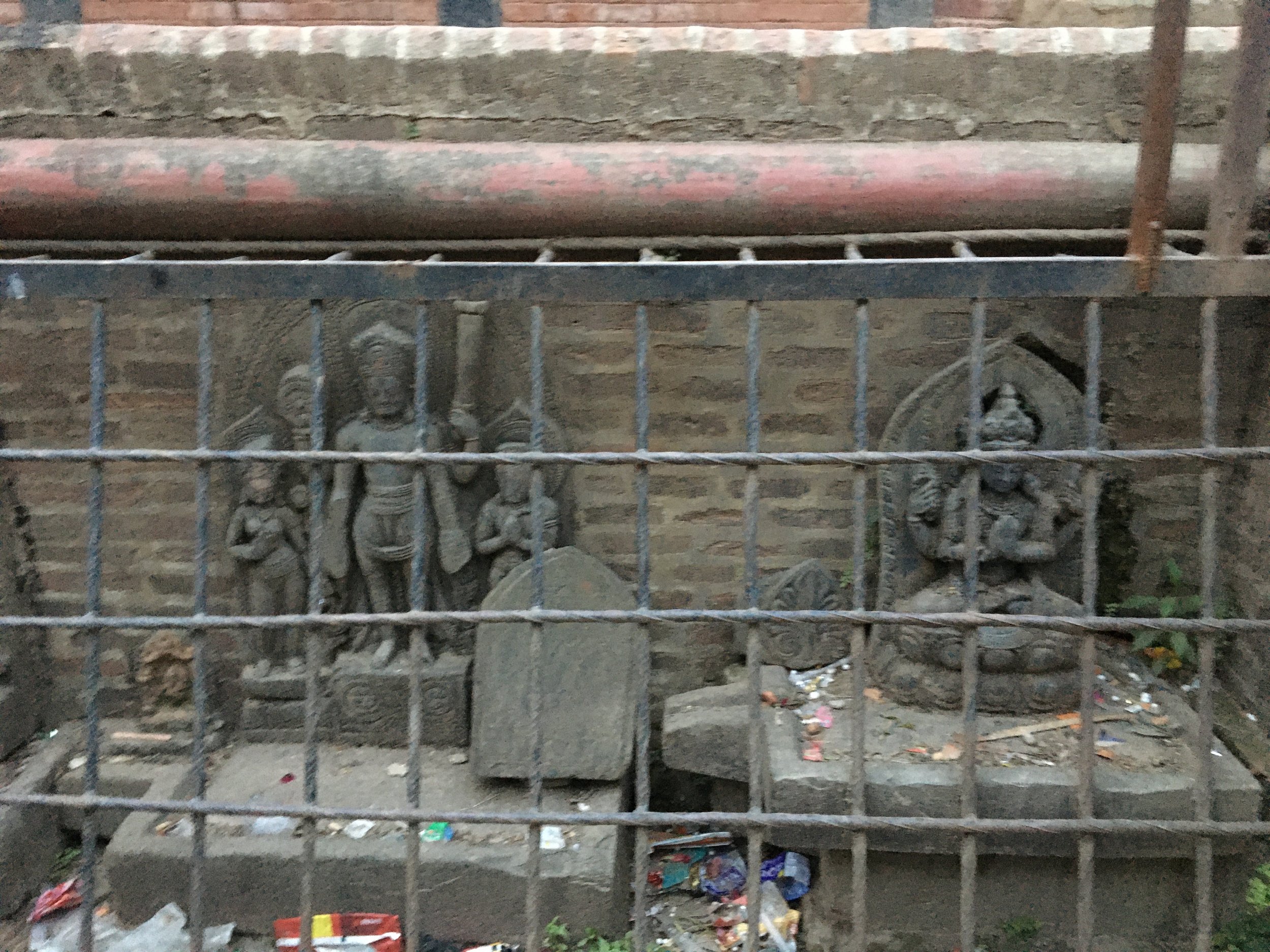  Statues protected by bars at  Chysal Hiti , Patan. 