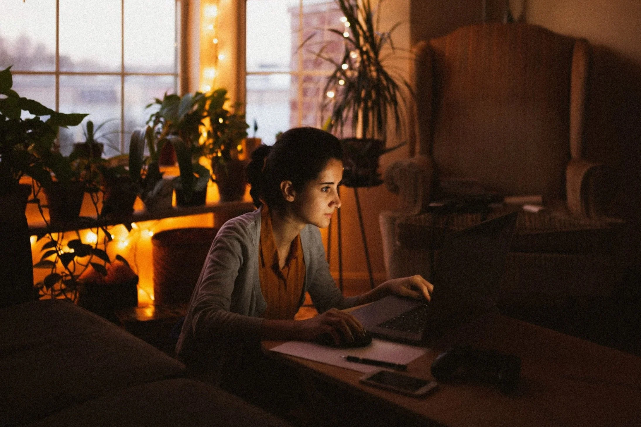 Person sitting quietly at night feeling emotionally exhausted and overwhelmed
