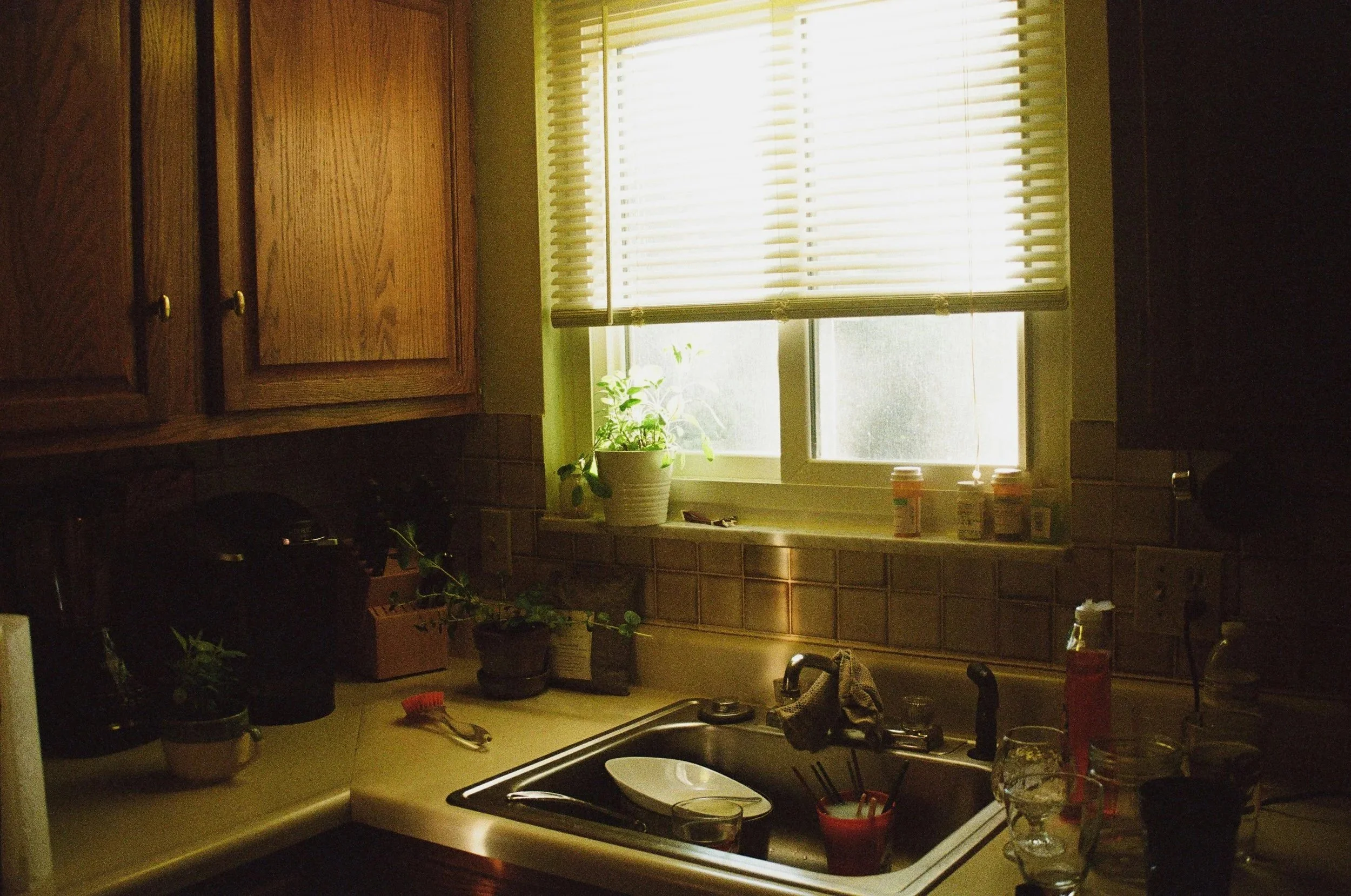 A kitchen sink full of dishes waiting to be washed