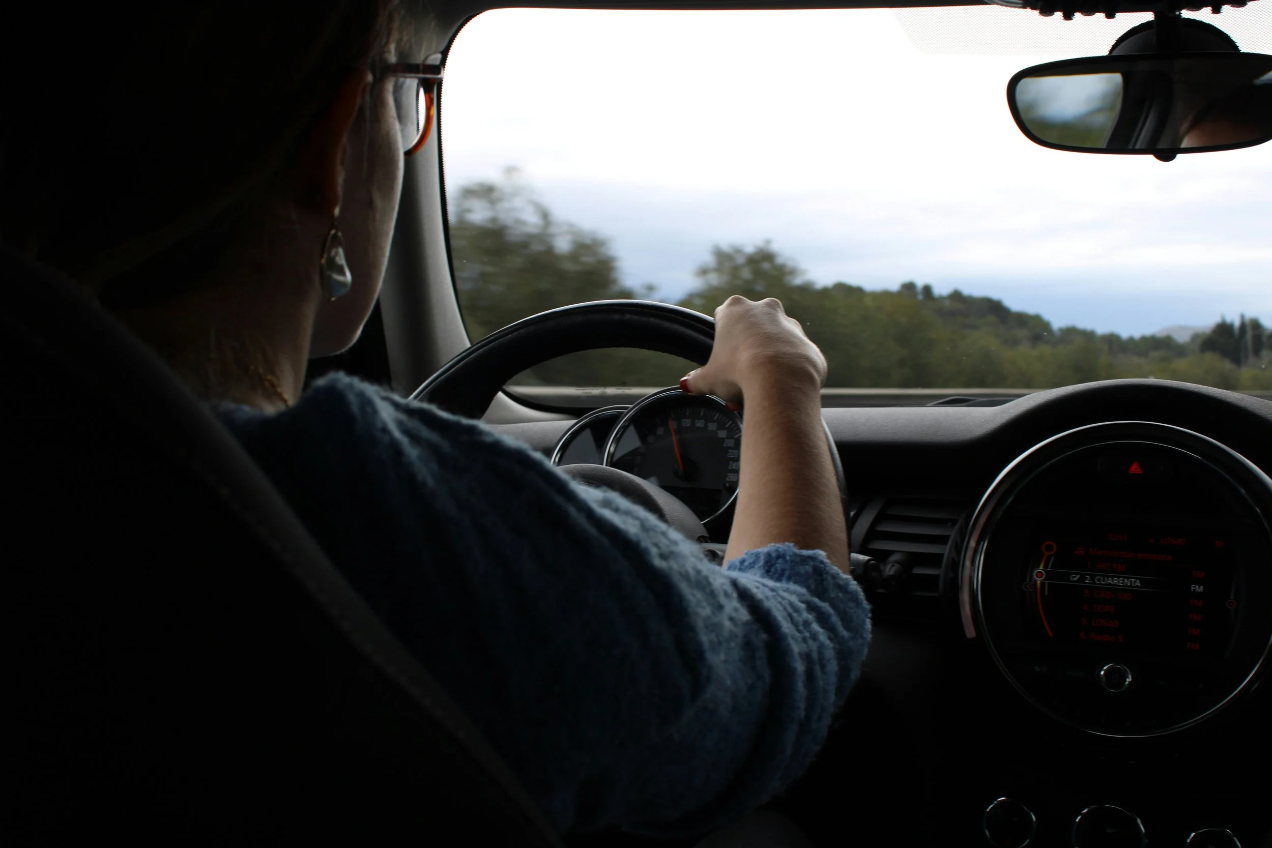 A person driving a car while lost in their thoughts
