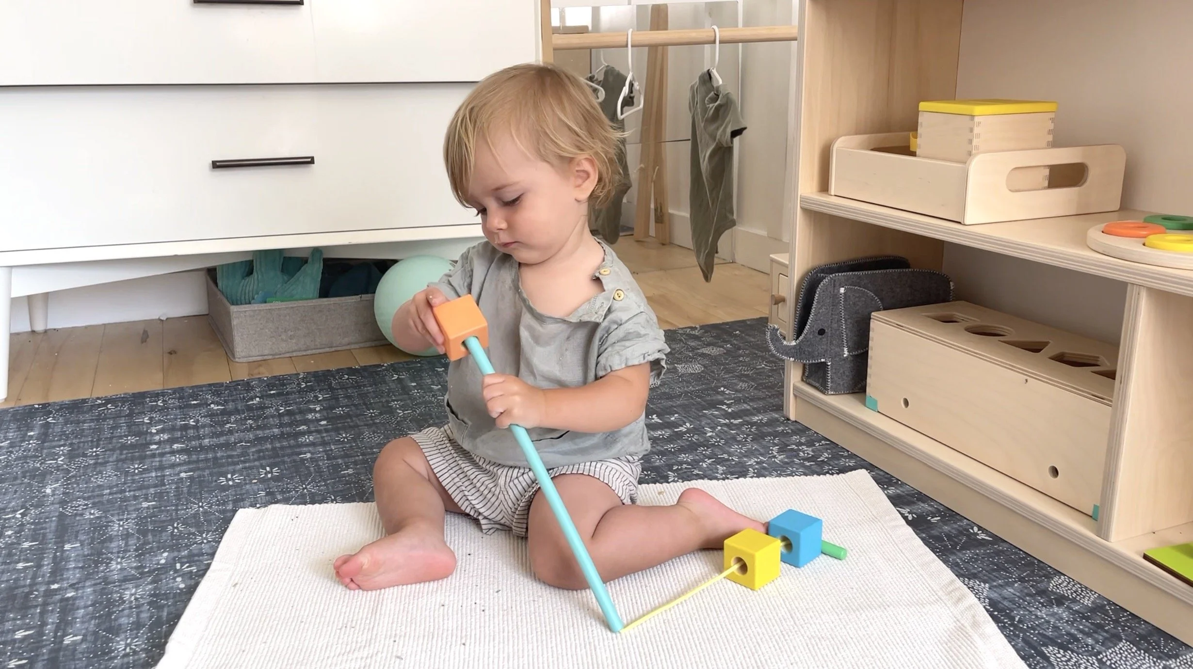 The threading material is a great Montessori activity at 15 months old