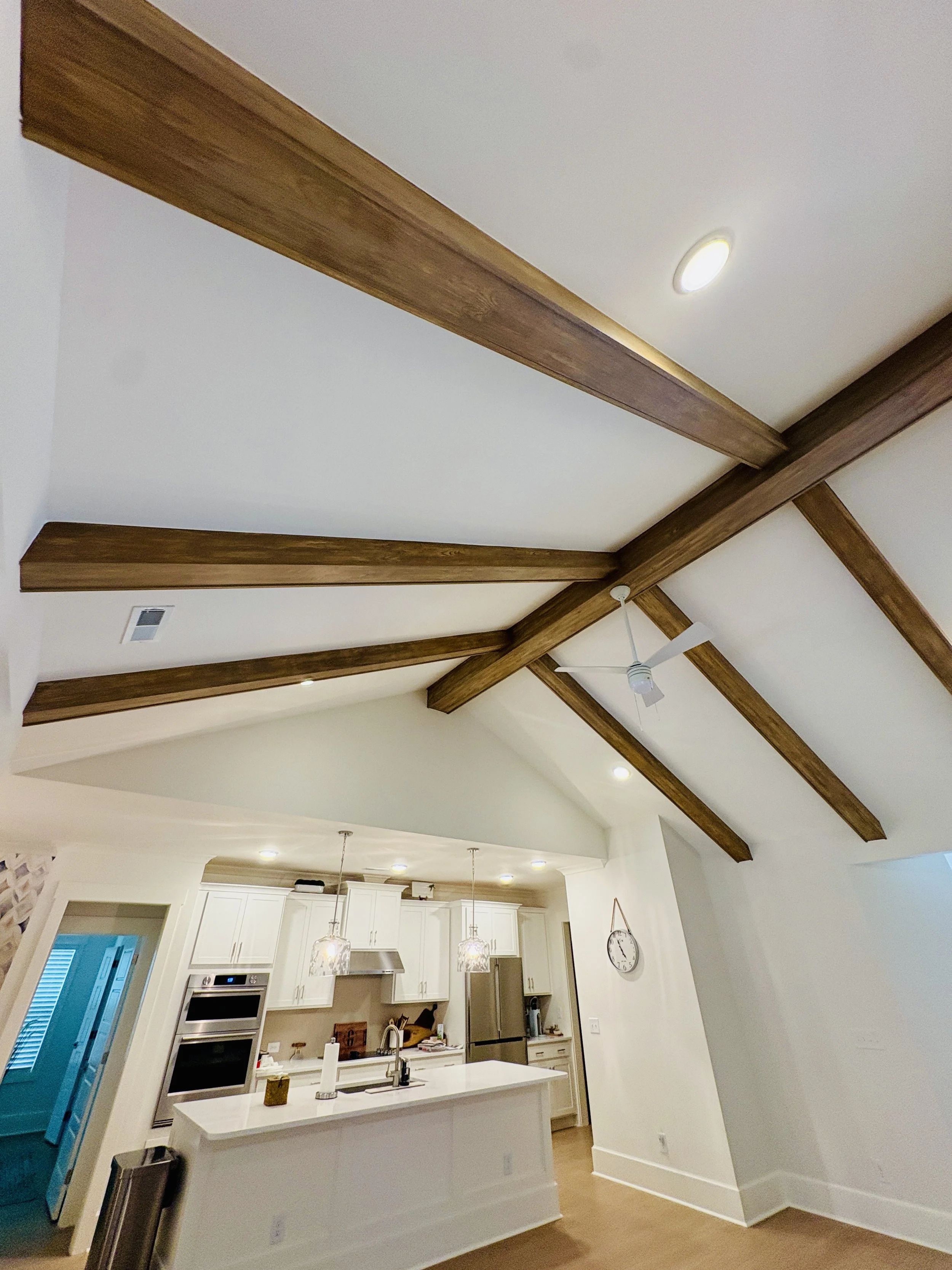 Faux grain effect on white beams gives this already beautiful living room warmth & charm