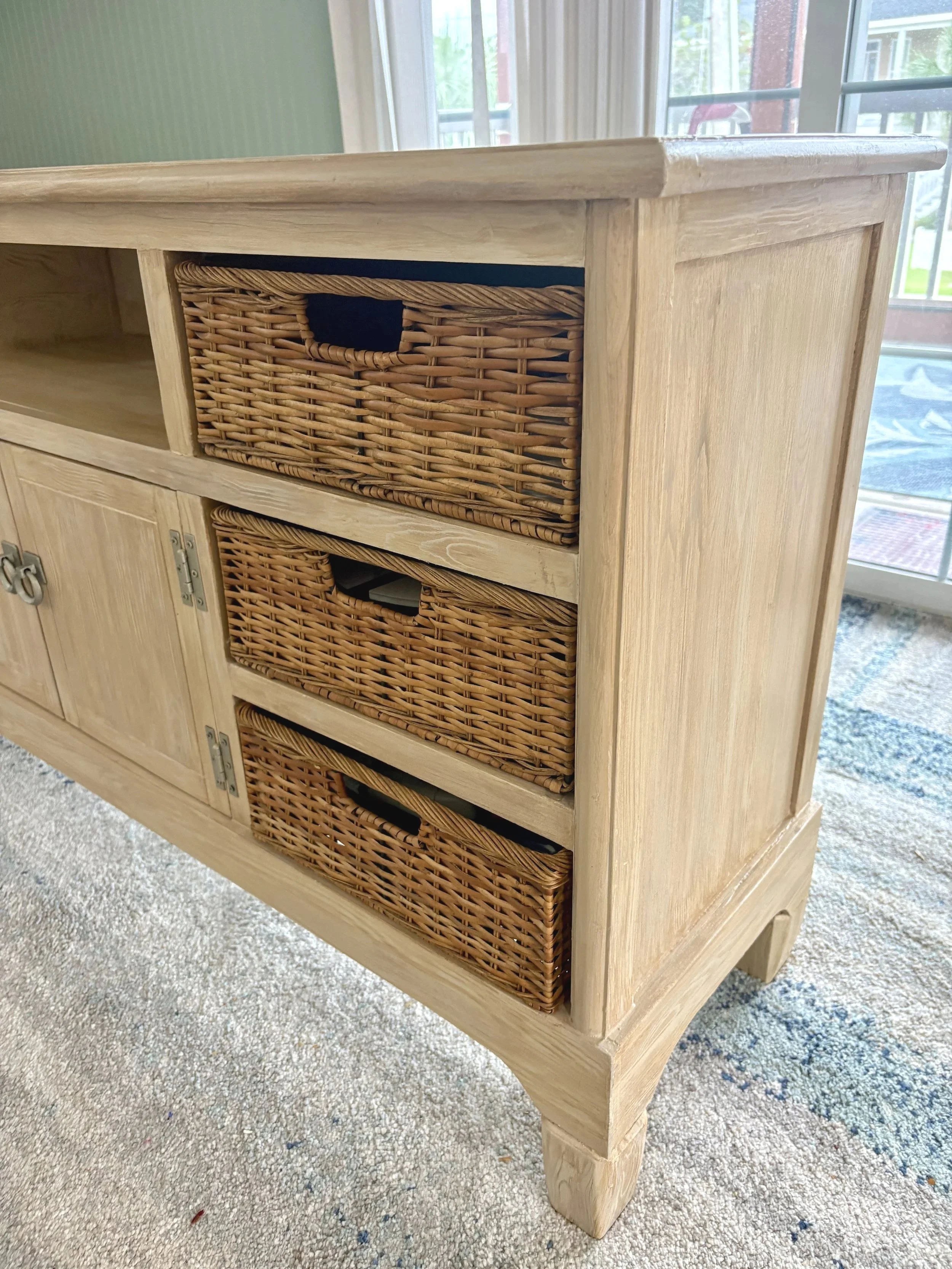 This unique piece was in much need of TLC. An off white laminate faux grained to bring a more coastal feel to room!