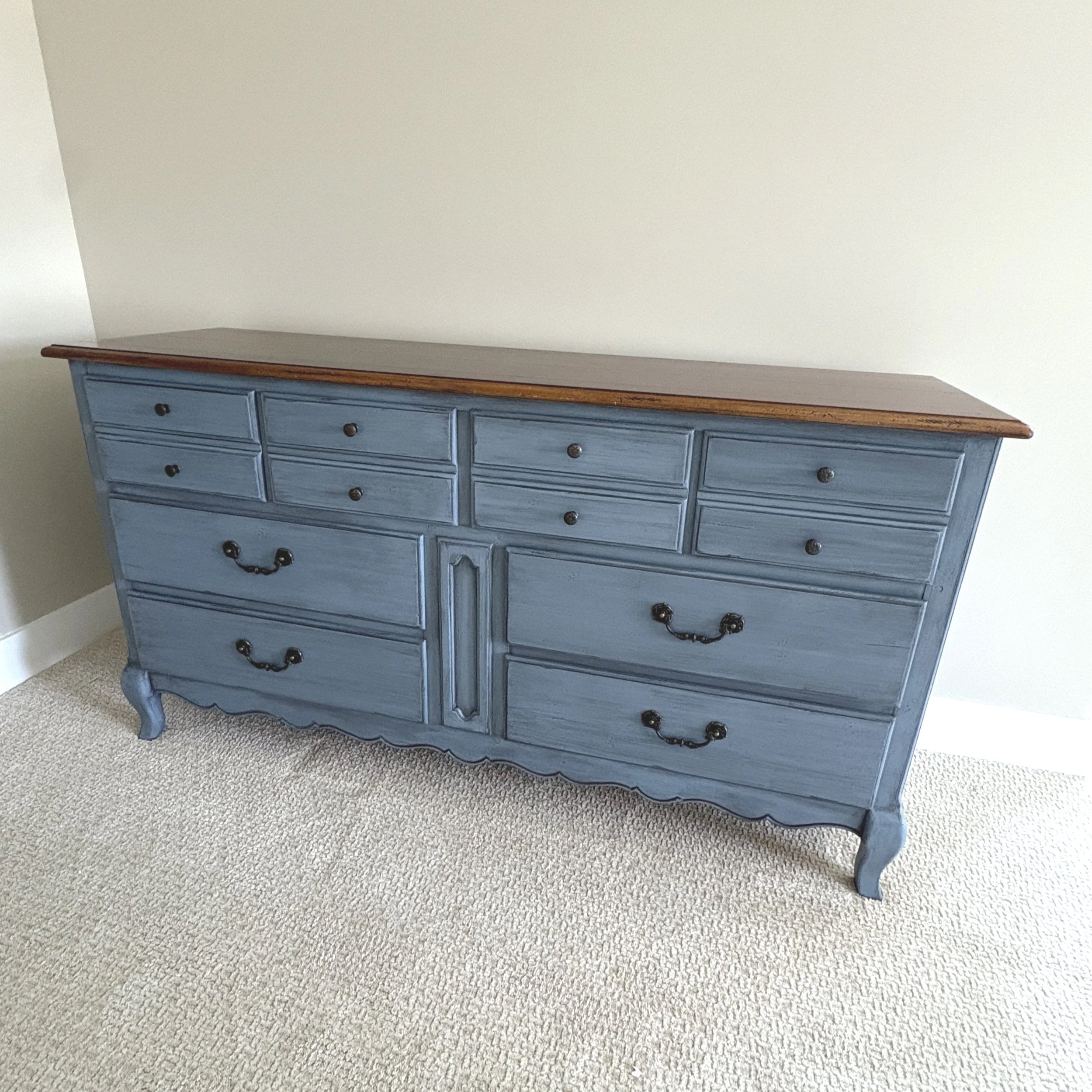 The original wood on top was throughout whole dresser. My client wanted to keep the top, but paint the bottom in a rich blue dry brush technique 
