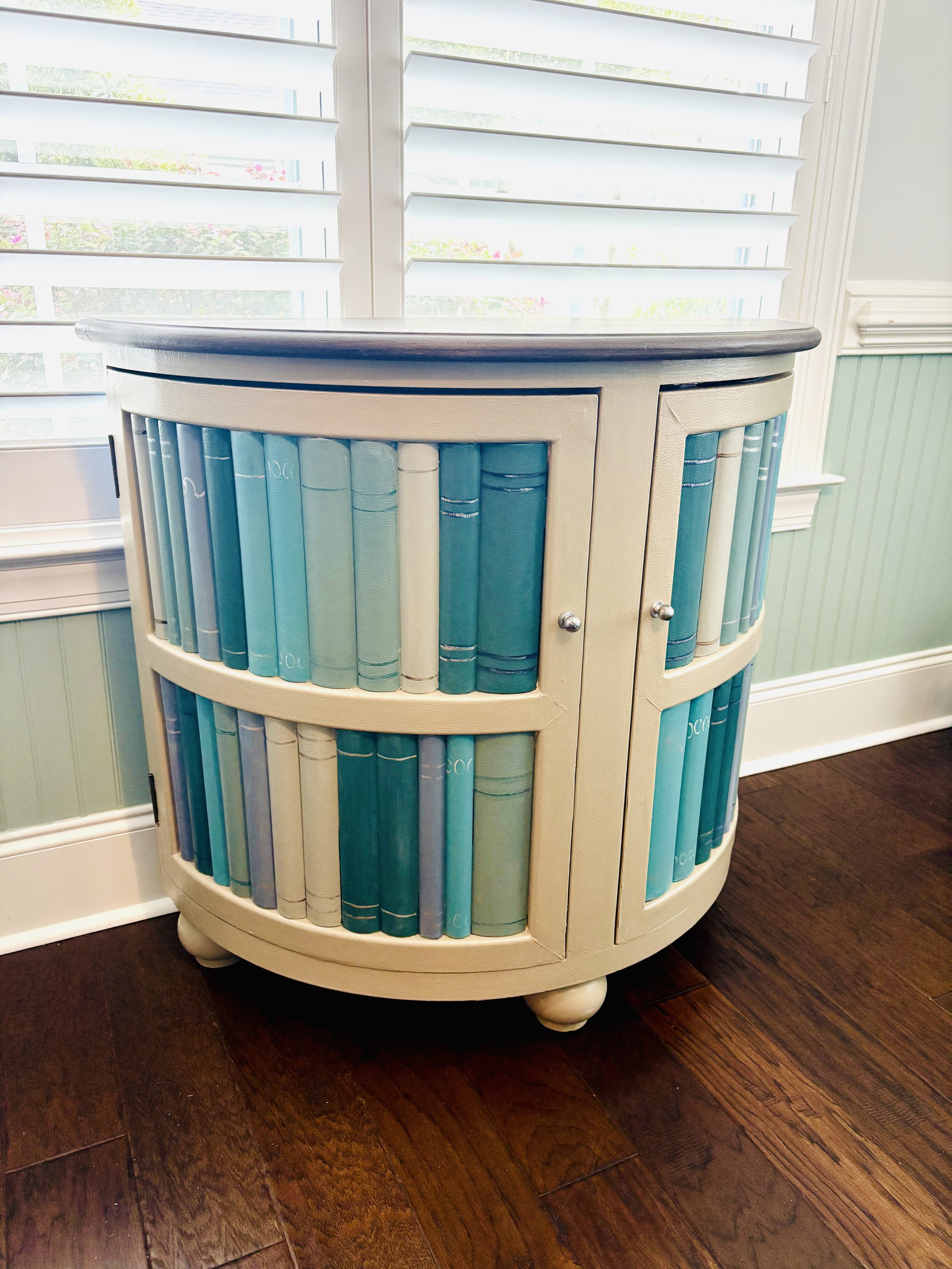 Dark faux book case refinished with shades of teals & blues
