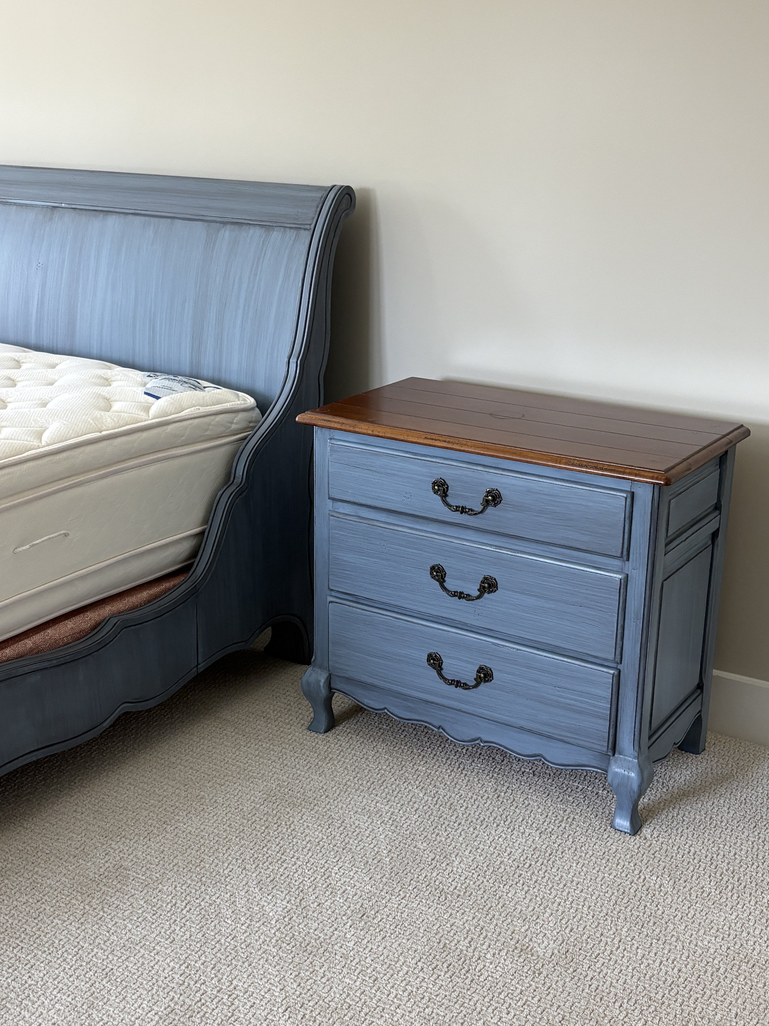 Dark wood furniture transformed with dry brush technique. The custom blue hue gives these bedroom pieces a more ornate feel. 