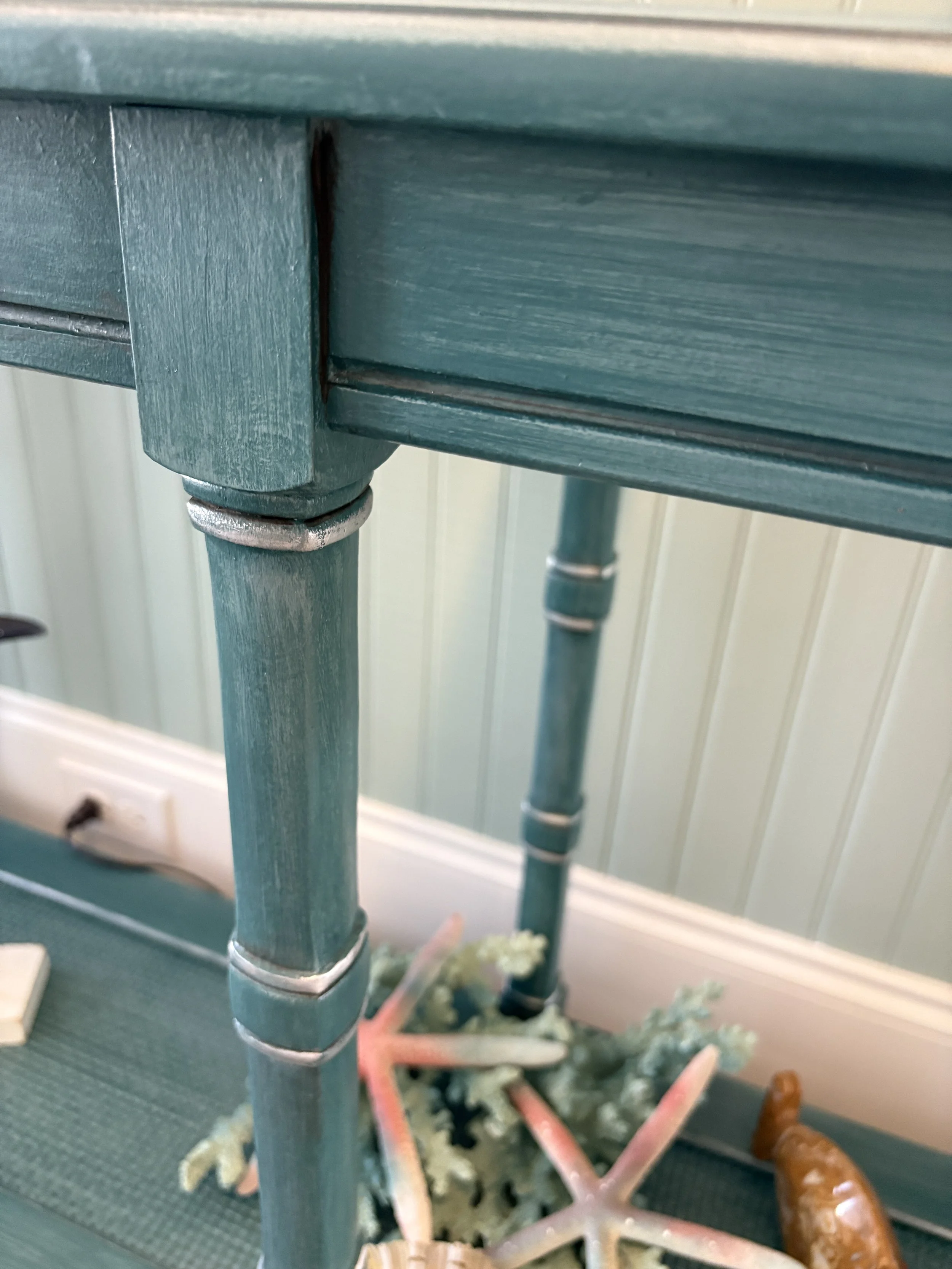 Tone on tone in shades of teal with silver metallic accent