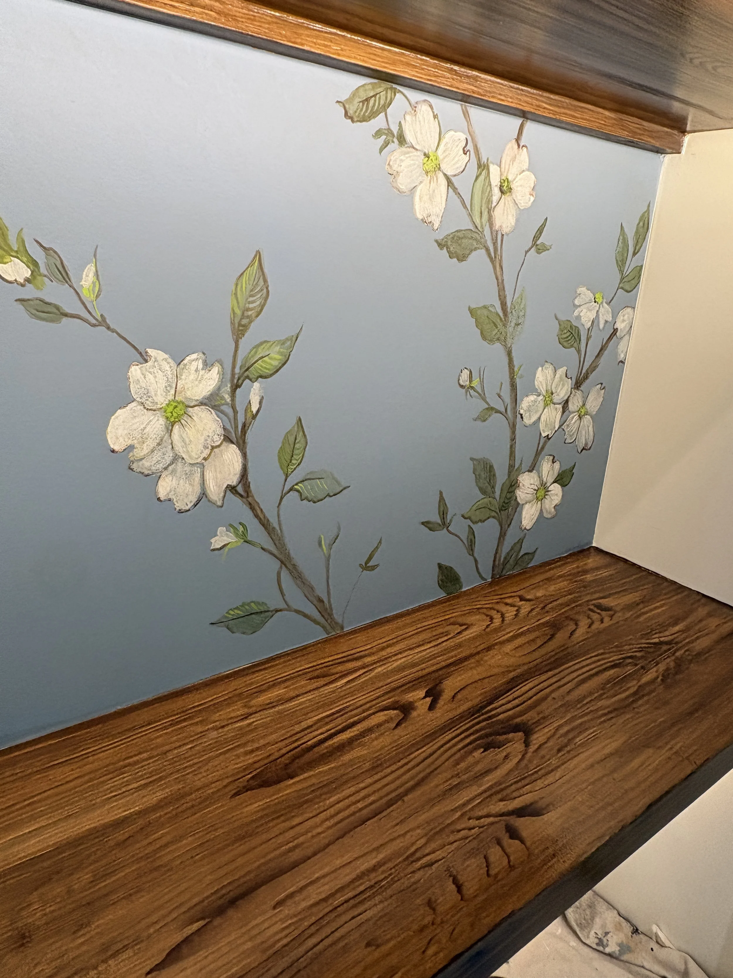 Faux grain finish on white bookshelves. Look how beautifully it flows with decorative painting. 