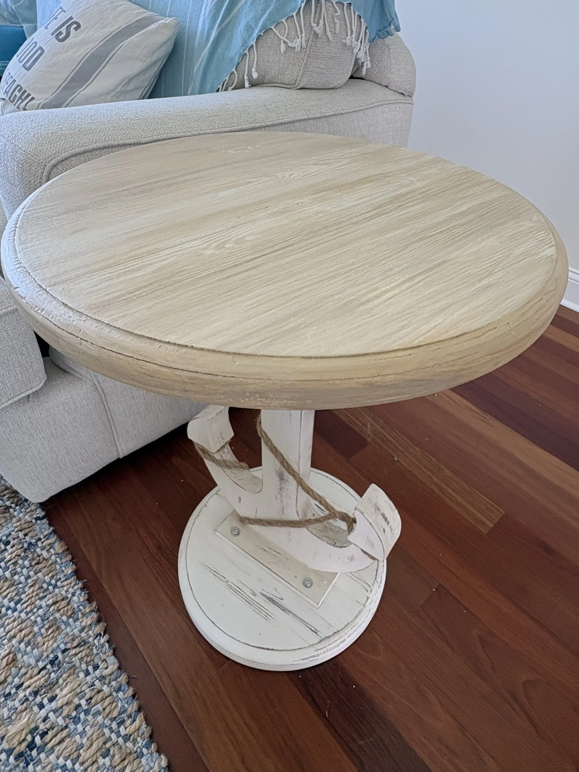 The top of this small accent piece was the same as the bottom. Faux graining just the top gives this whimsical anchor  table a more coastal feel. 