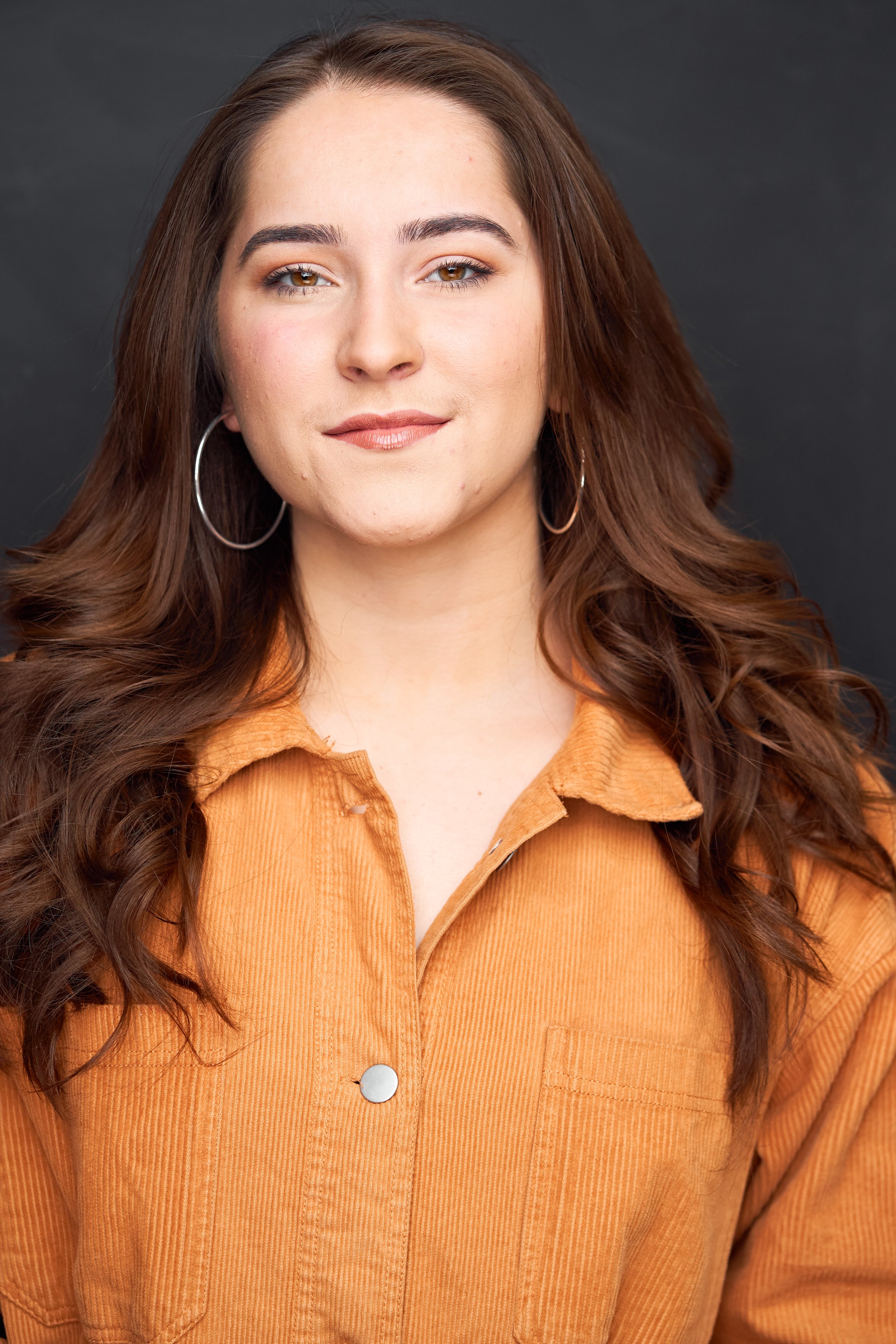 Headshot Orange 2.jpg