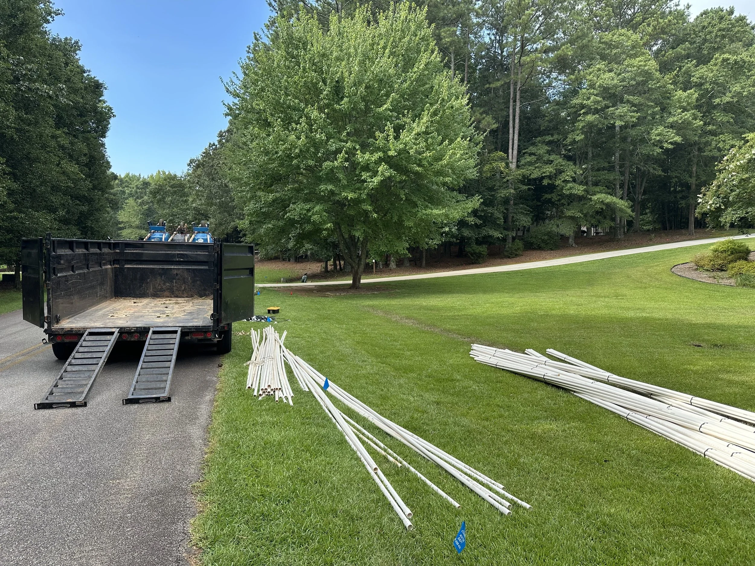 Irrigation pipe materials staged on a residential property prior to installation by Southern Grounds Landscaping in Watkinsville Georgia