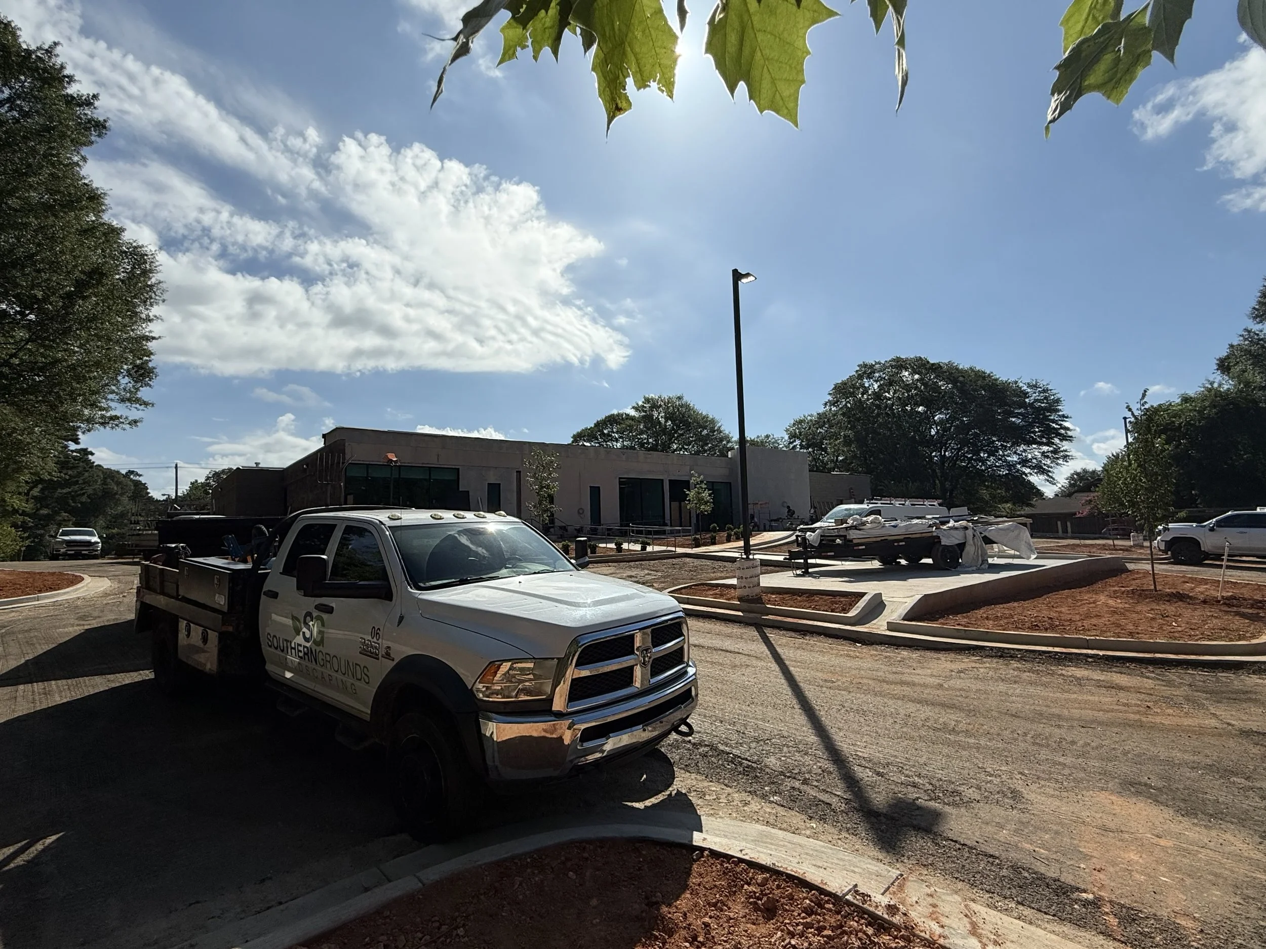 Commercial landscape service truck on-site at a professional business complex.