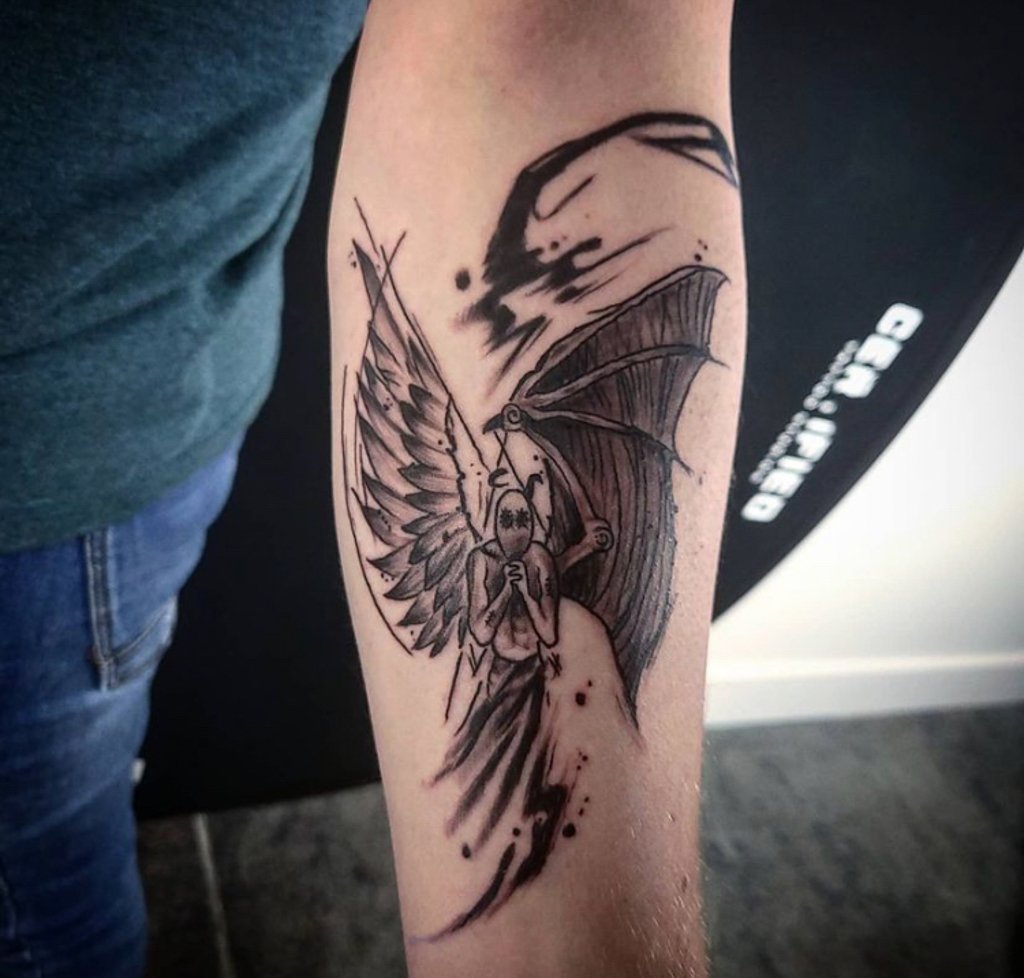 Close-up photograph of a skull with wings gothic tattoo design
