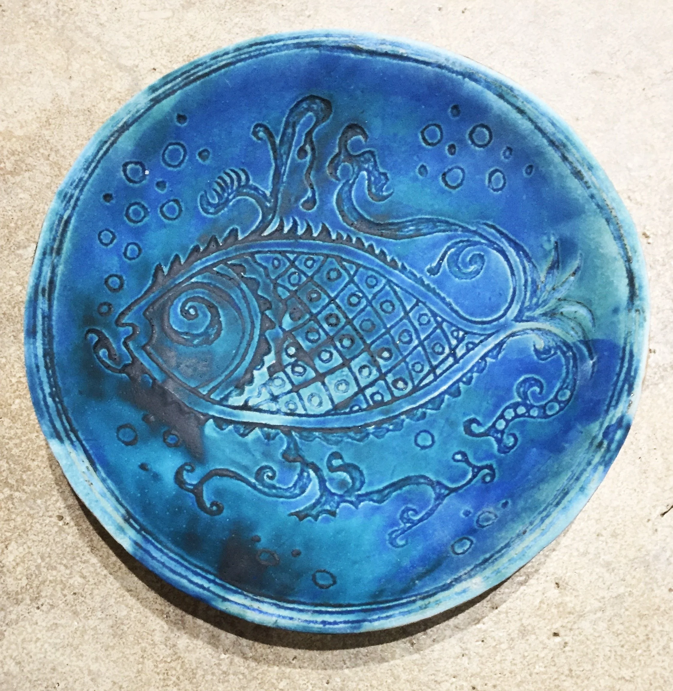 Hand built dish, sgraffito design, barium glaze.