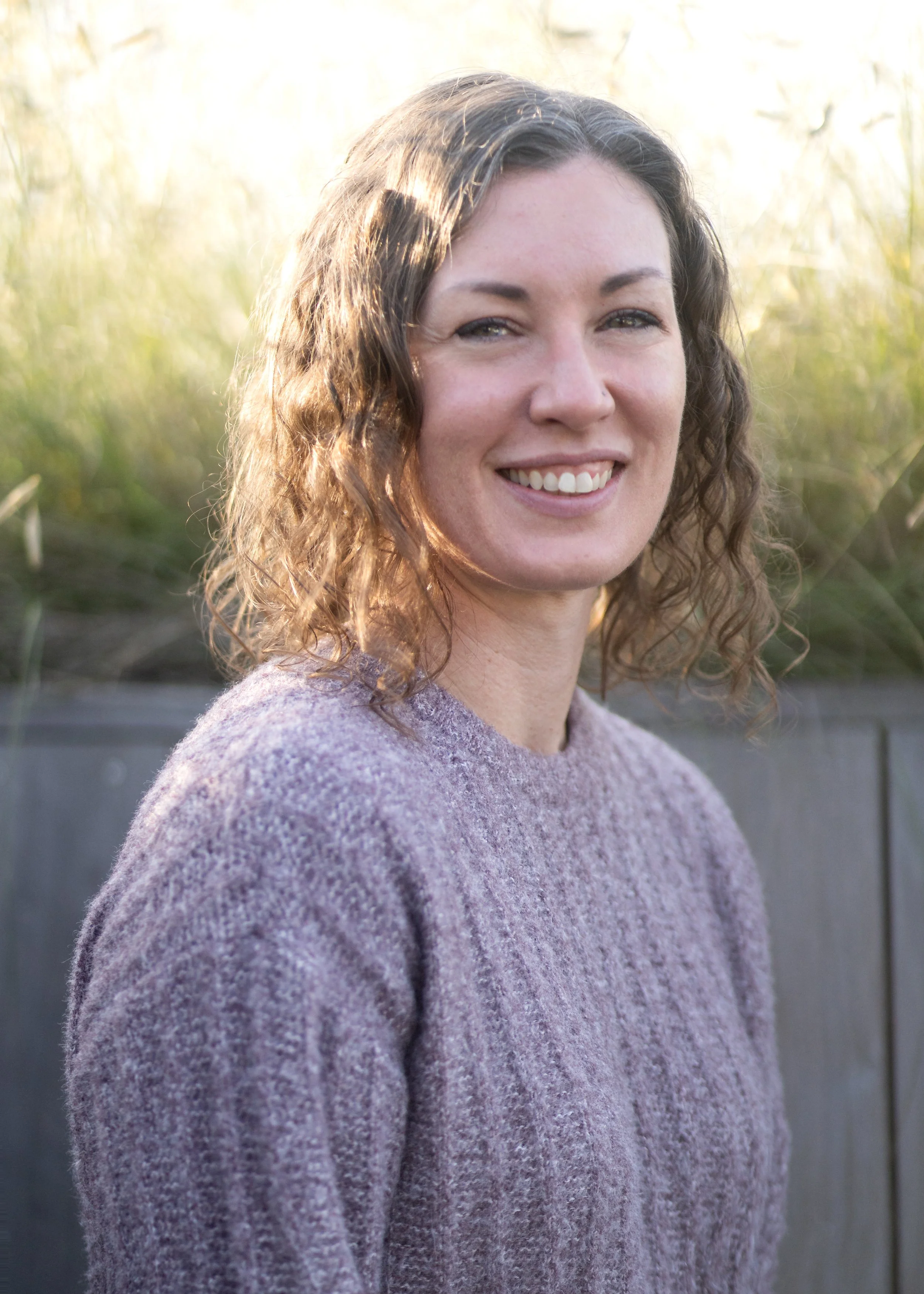 A smiling woman sitting outdoors